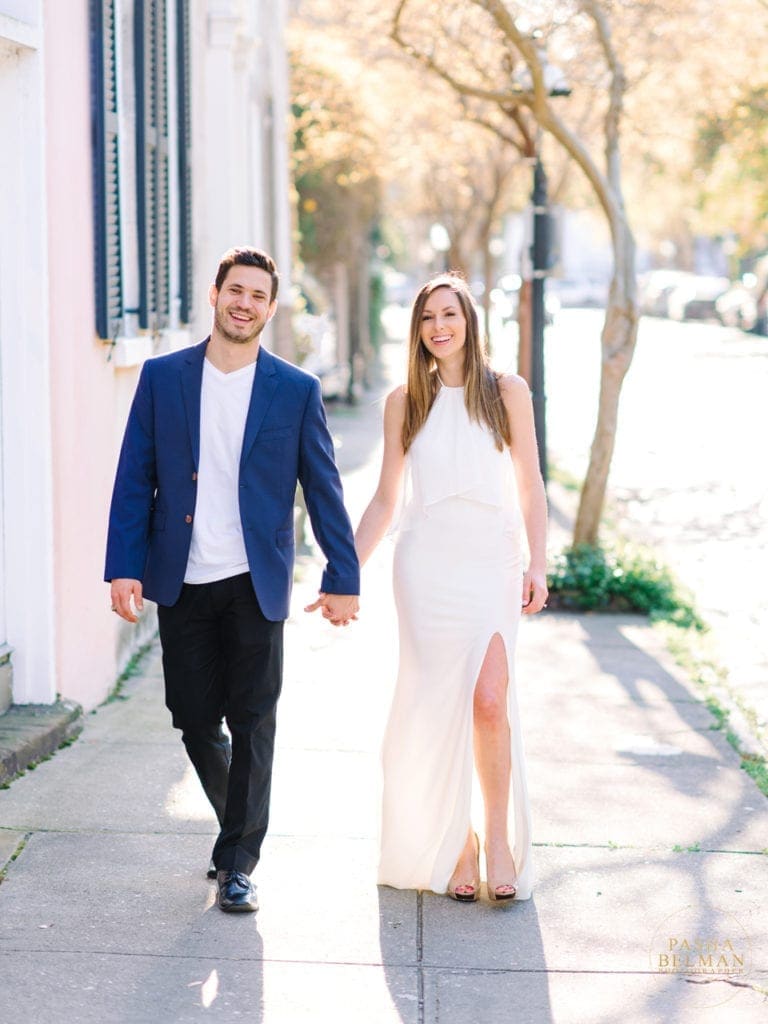 Engaged couple walking during downtown Charleston engagement session
