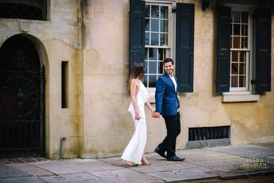 Couple walking during downtown Charleston engagement session
