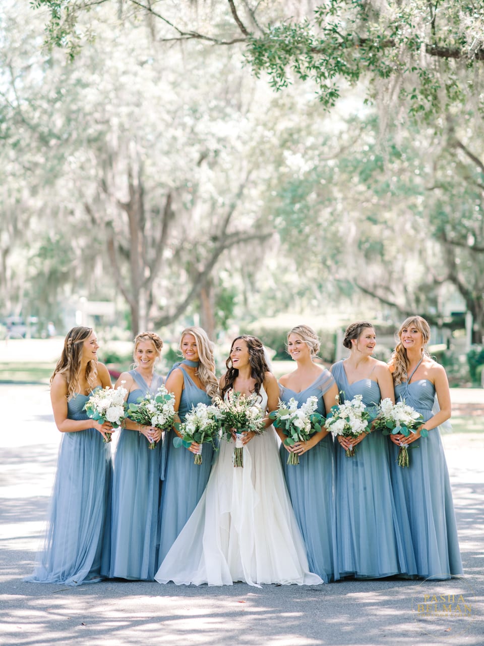 Bride and bridesmaids pose ideas at Wachesaw Plantation by Pasha Belman Photography. Gorgeous blue bridesmaids dresses.