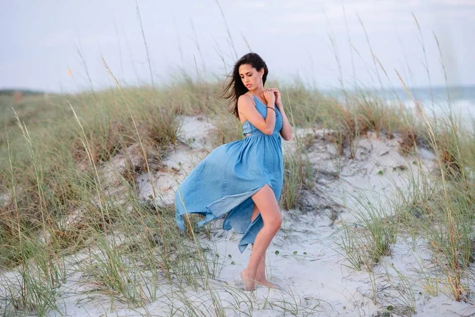 Beach senior portrait with natural posing and ocean waves