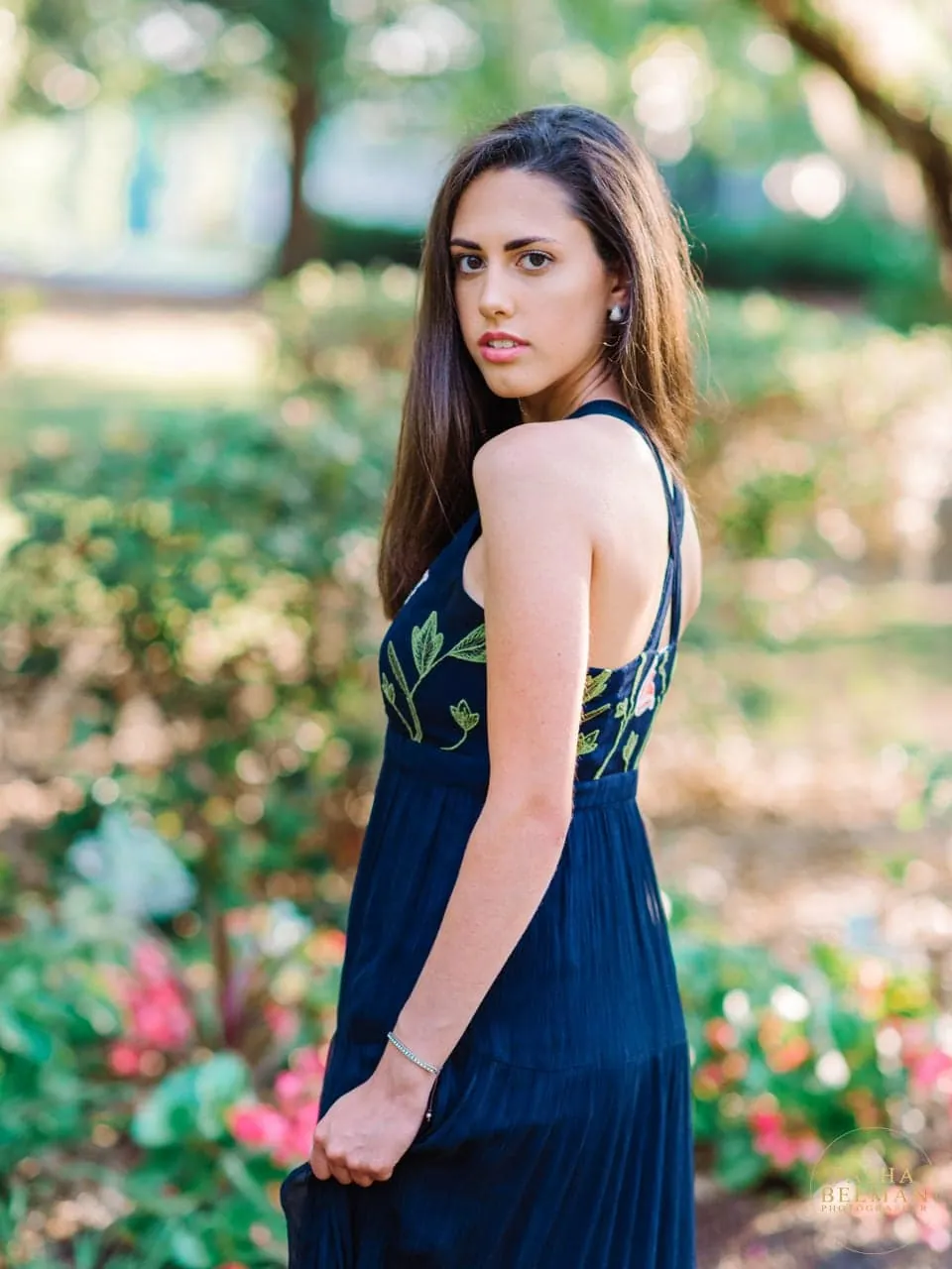 Modern beach senior portrait with clean horizon and soft light