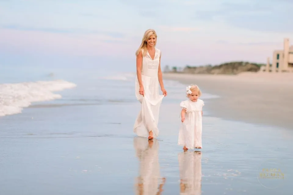 All white beach family photo outfits photographed with soft natural coastal light