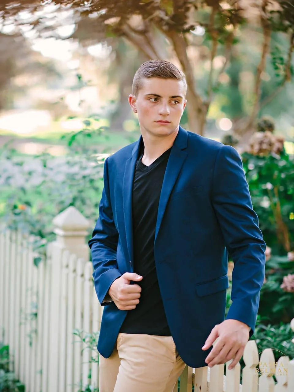 Senior guy leaning against an oak tree draped in moss near Myrtle Beach