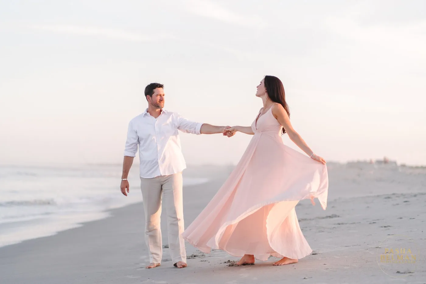 Soft pink and white family beach photo outfits with natural coastal light