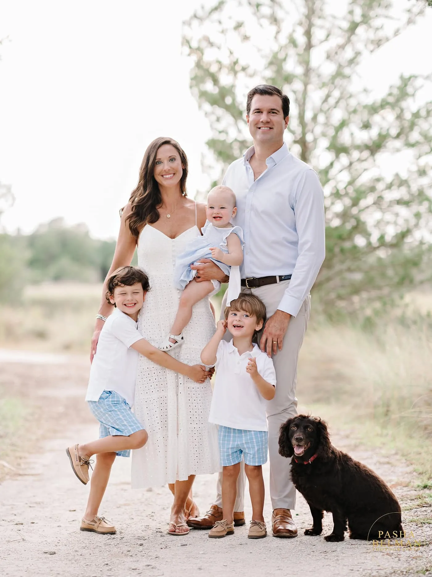 Women and girls in flowy coordinated beach outfits during family portrait session