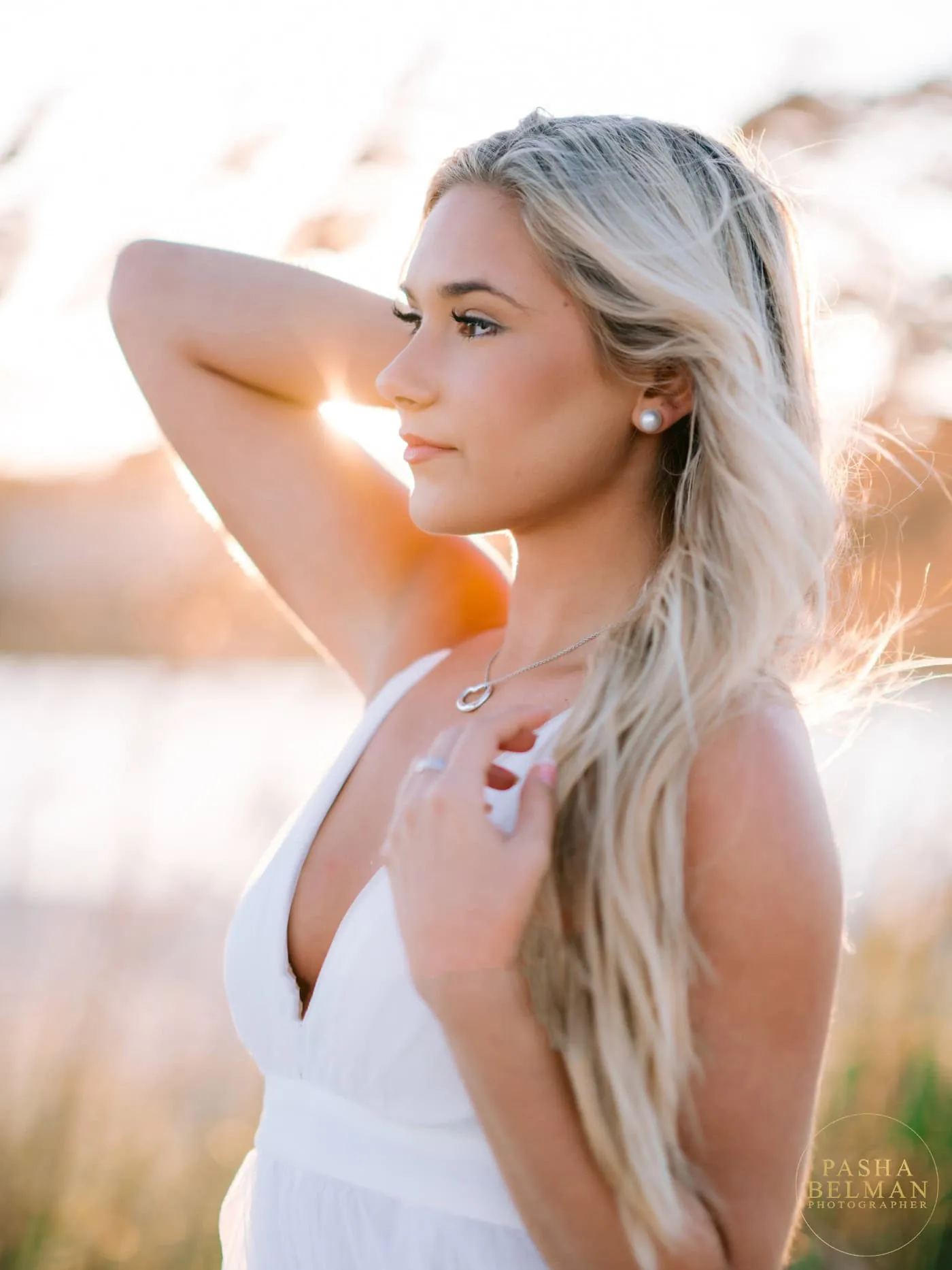 Senior portrait at Pawleys Island with ocean and dune backdrop