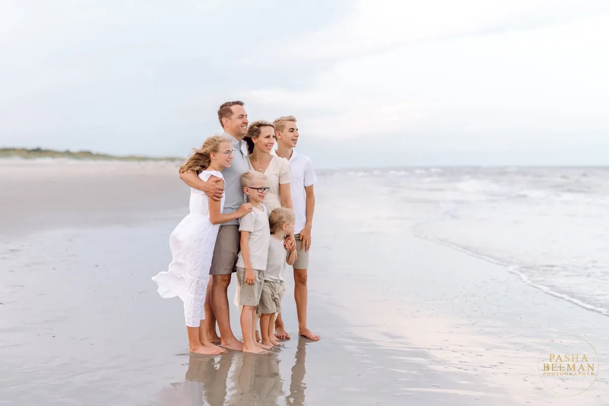 White and gray family beach photo outfits photographed with soft coastal tones