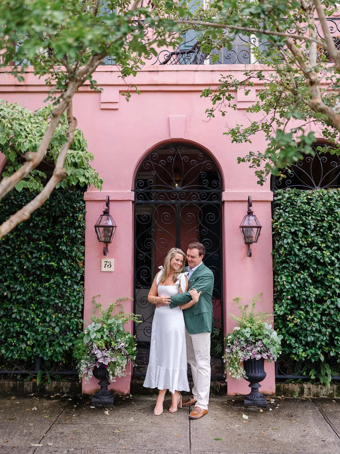 Charleston engagement portrait with pastel historic architecture
