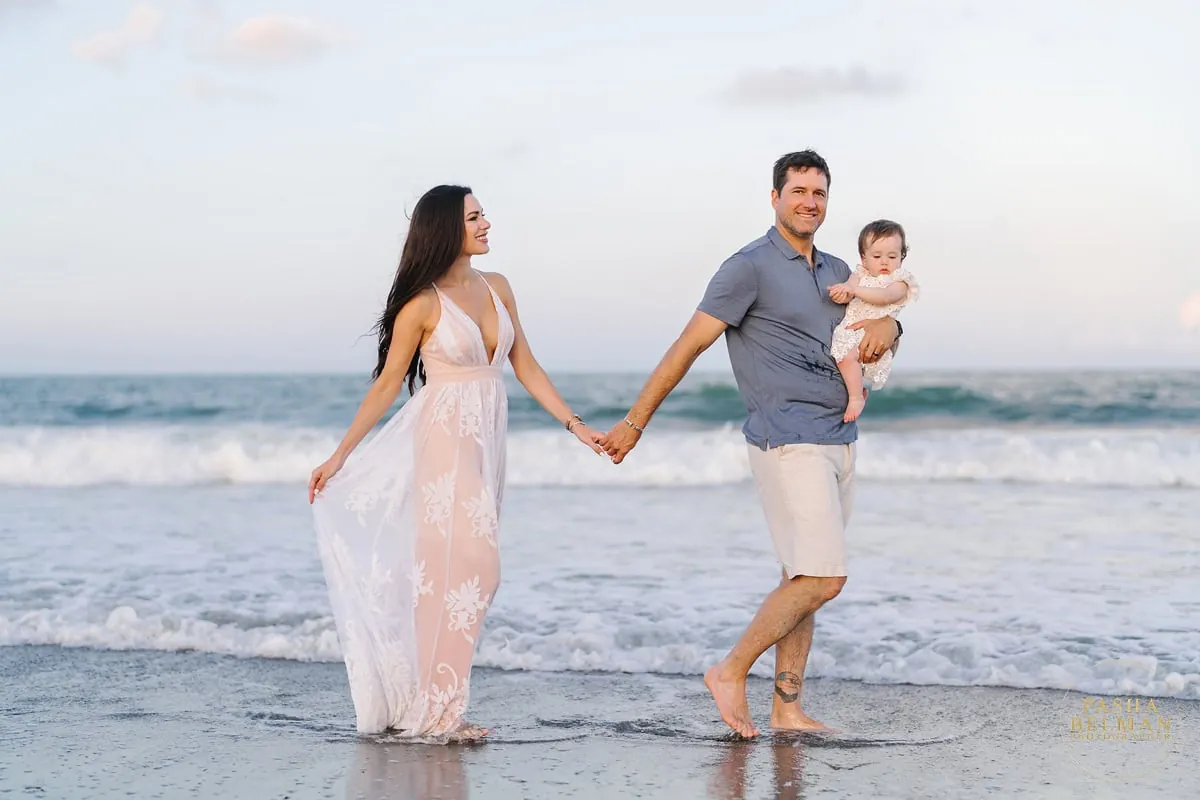 Coordinated family beach photo outfits with soft coastal light and natural movement along the shoreline