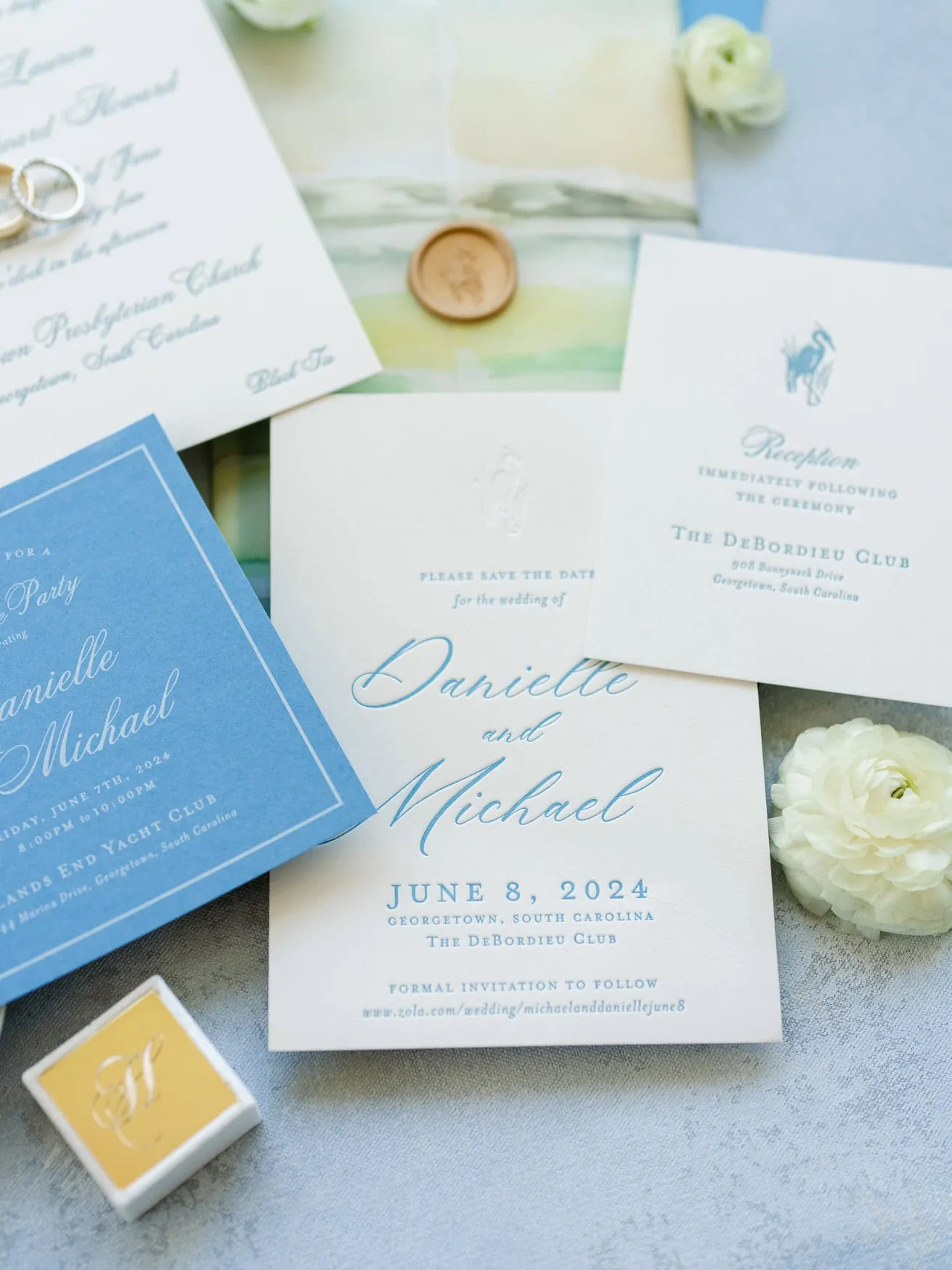 Elegant wedding invitation suite featuring white and blue cards with stylish calligraphy, floral accents, and matching stationery for a romantic South Carolina wedding.