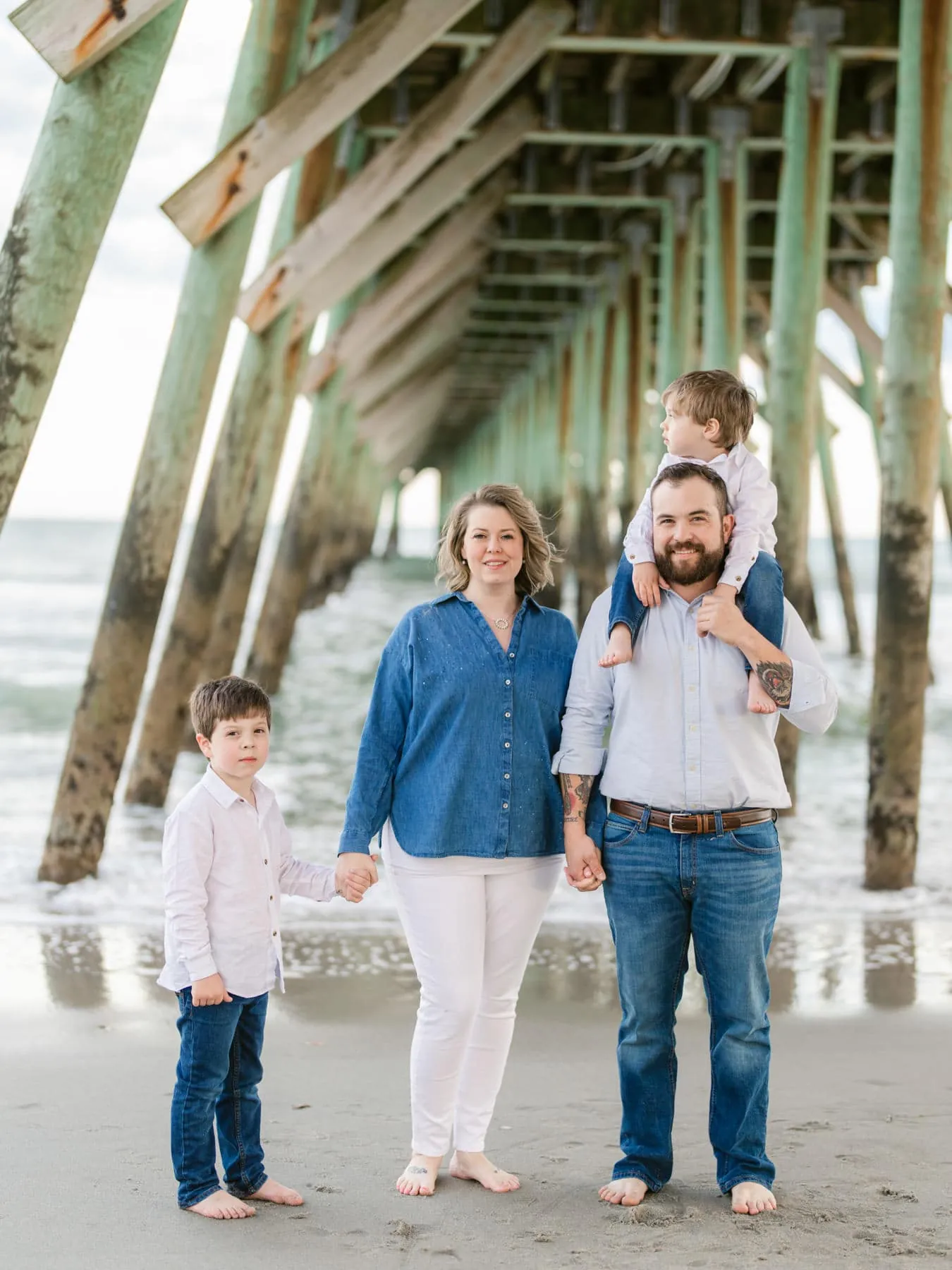 Children running through the waves during a family session in Myrtle Beach