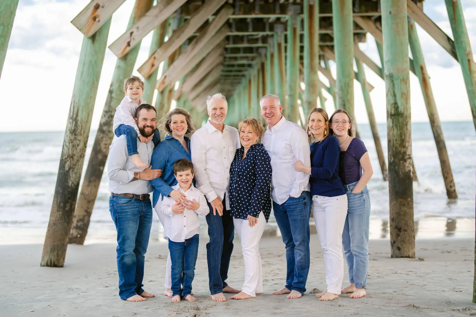 Grandparents and grandchildren sharing a moment on the sand in Myrtle Beach