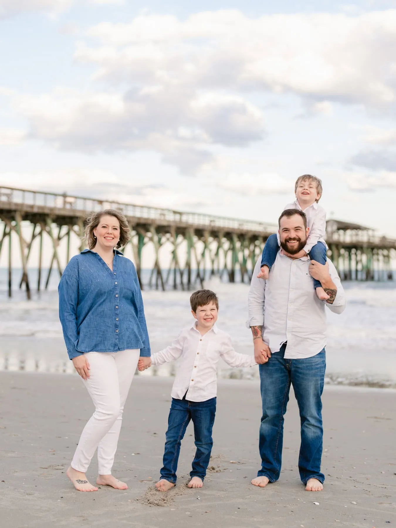 Parents and children laughing together during a Myrtle Beach beach photo session