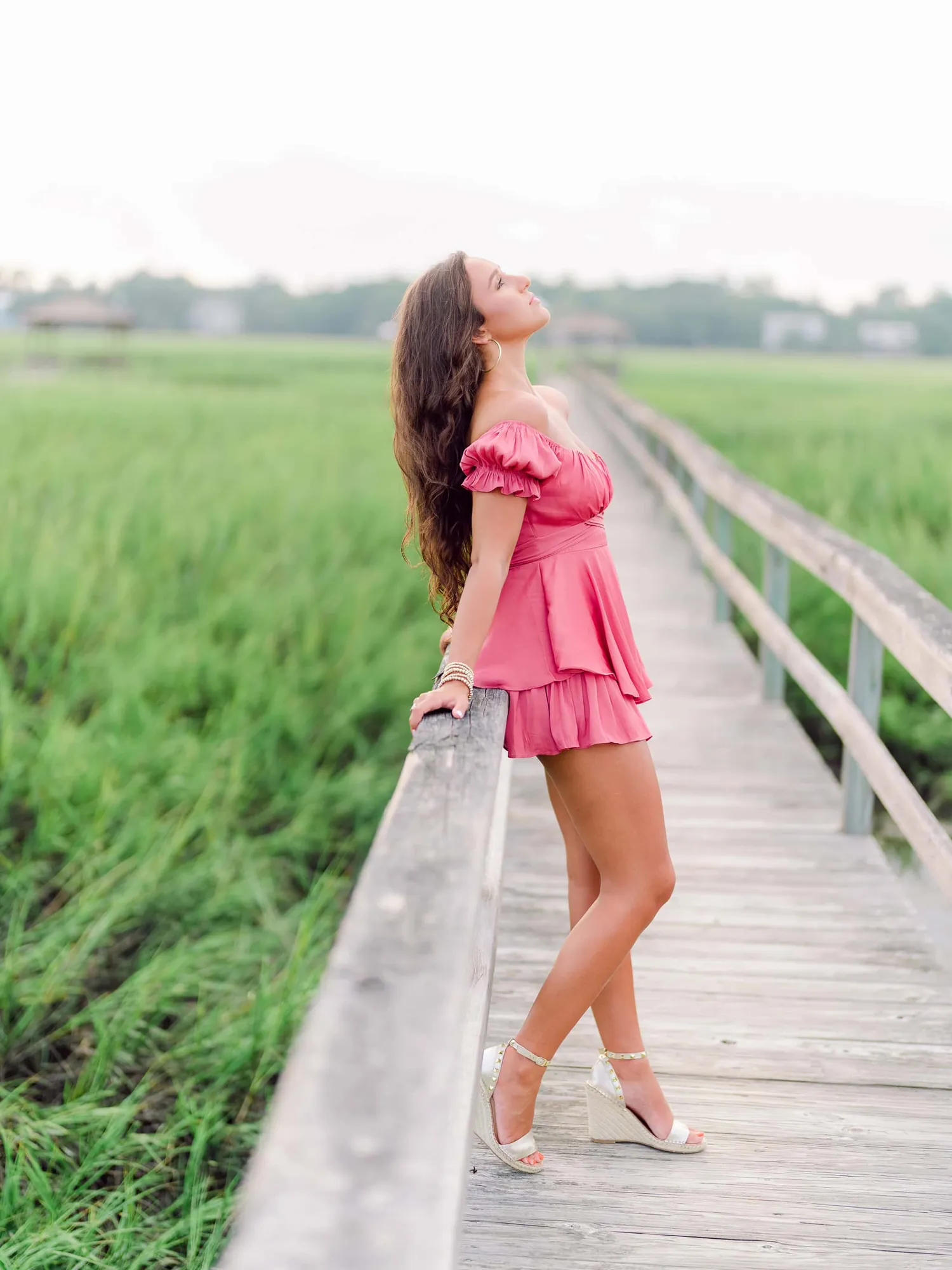 Pawleys Island senior photos of a high school senior posing naturally on a quiet beach at golden hour