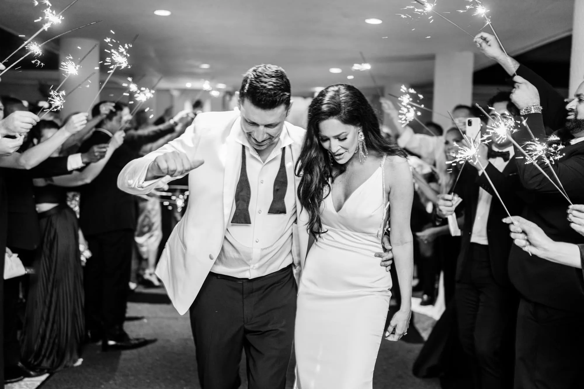 Bride and groom walking hand-in-hand during their Dunes Golf Club wedding