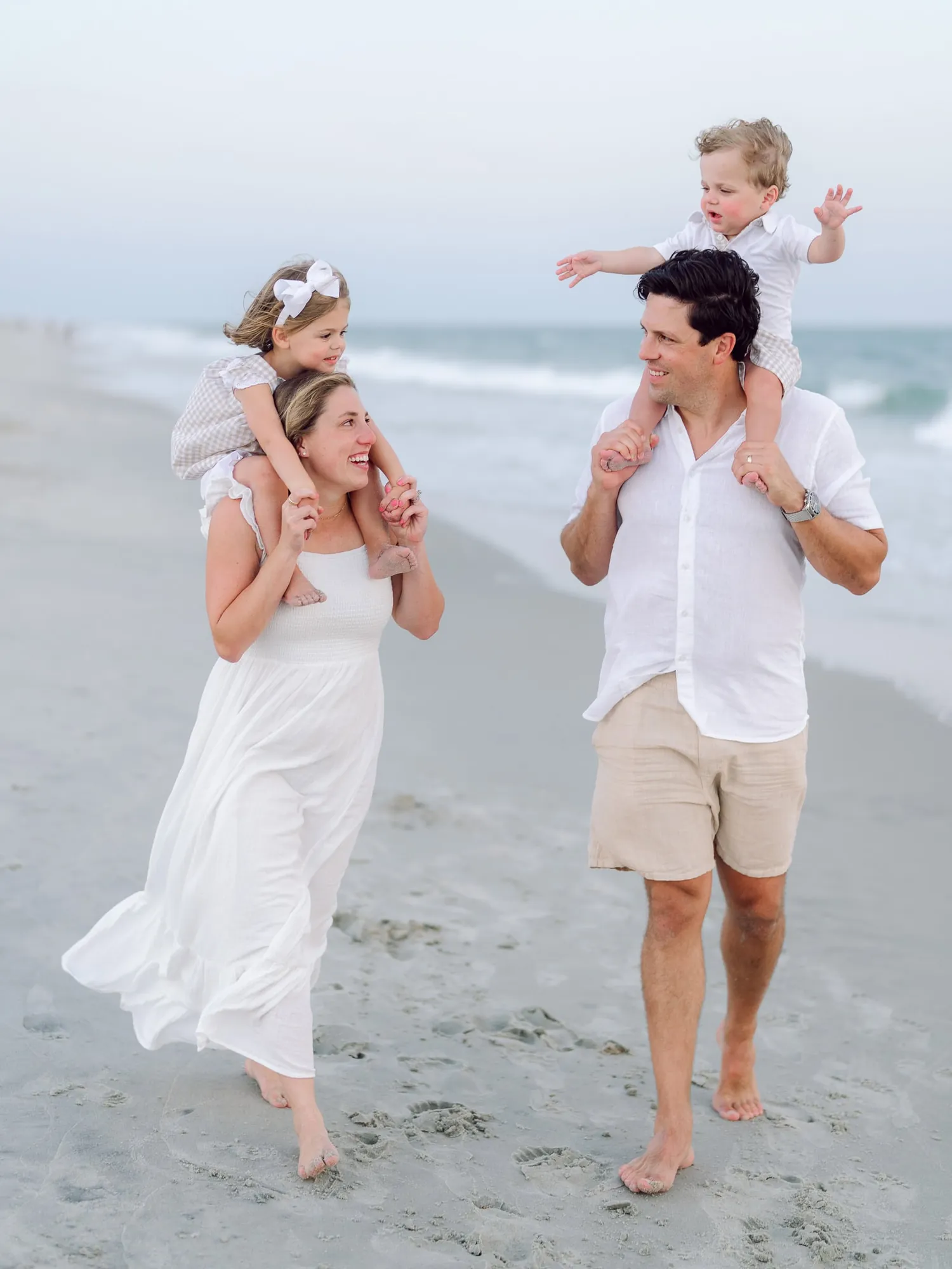 Family in coordinated outfits during a Myrtle Beach beach portrait session on the Grand Strand