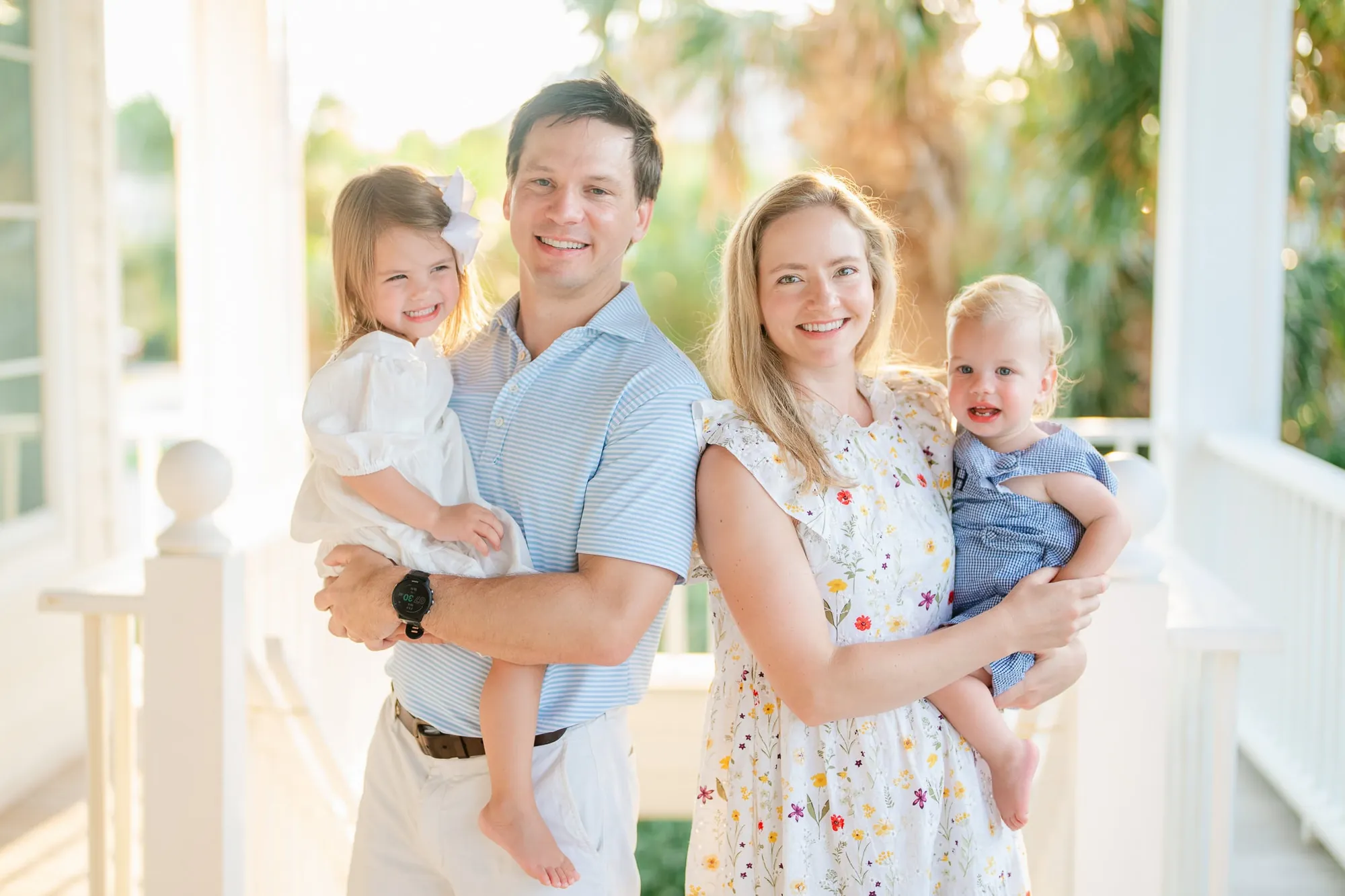 Family playing in yard of beach vacation rental, casual candid moment with kids running