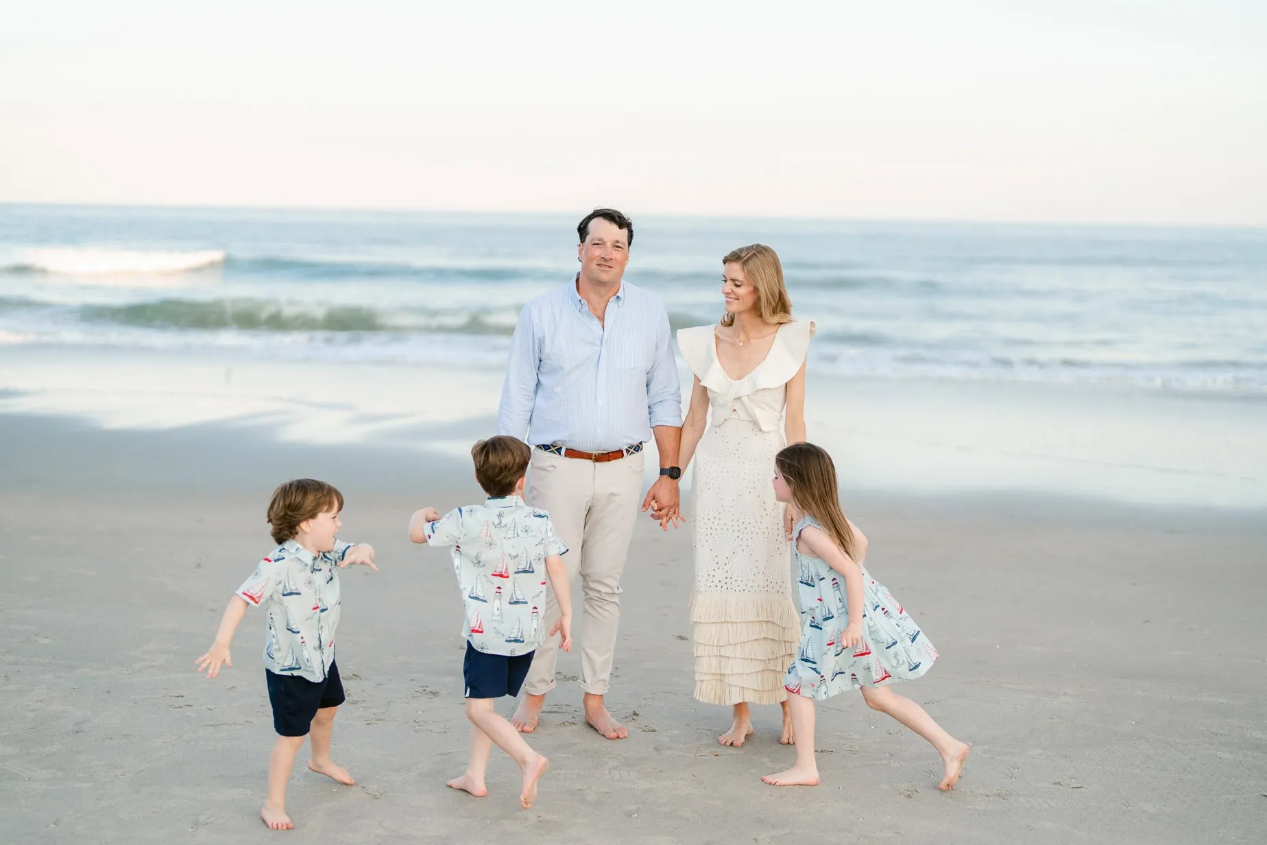 Family beach portraits in Myrtle Beach with coordinated neutral outfits