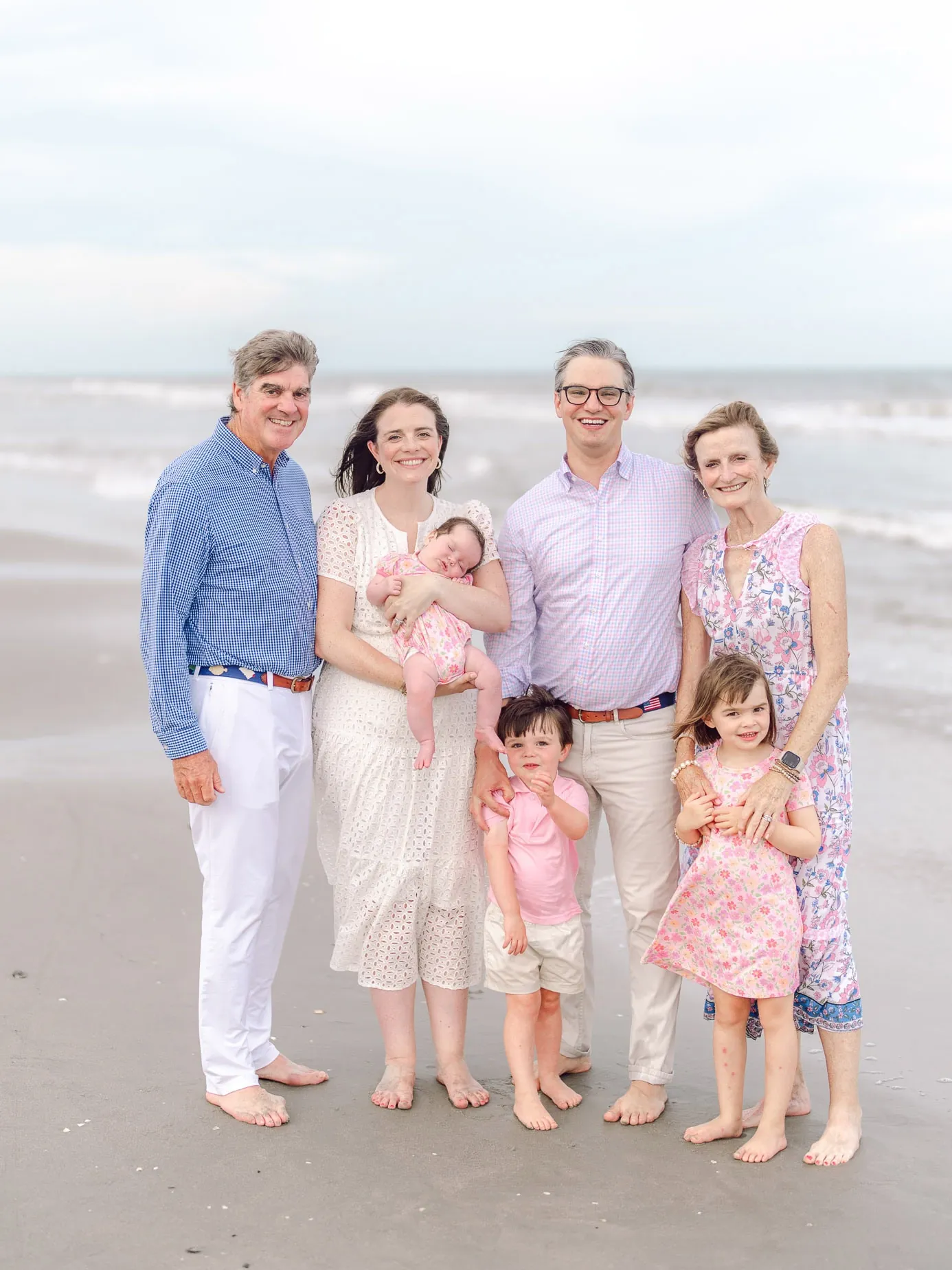 Multigenerational family portrait with grandparents parents and children along the Myrtle Beach shoreline