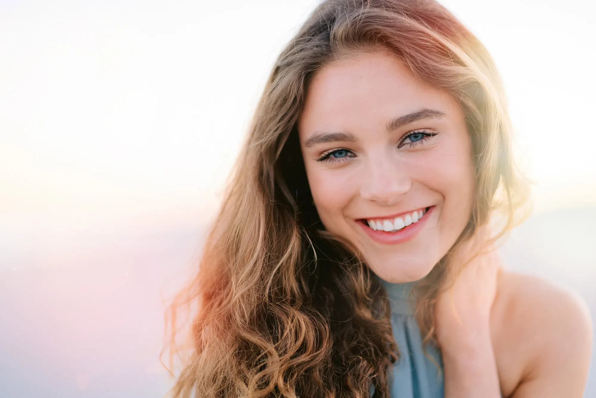 Natural outdoor senior portrait photographed in Myrtle Beach SC with relaxed expression and soft golden hour light by Pasha Belman