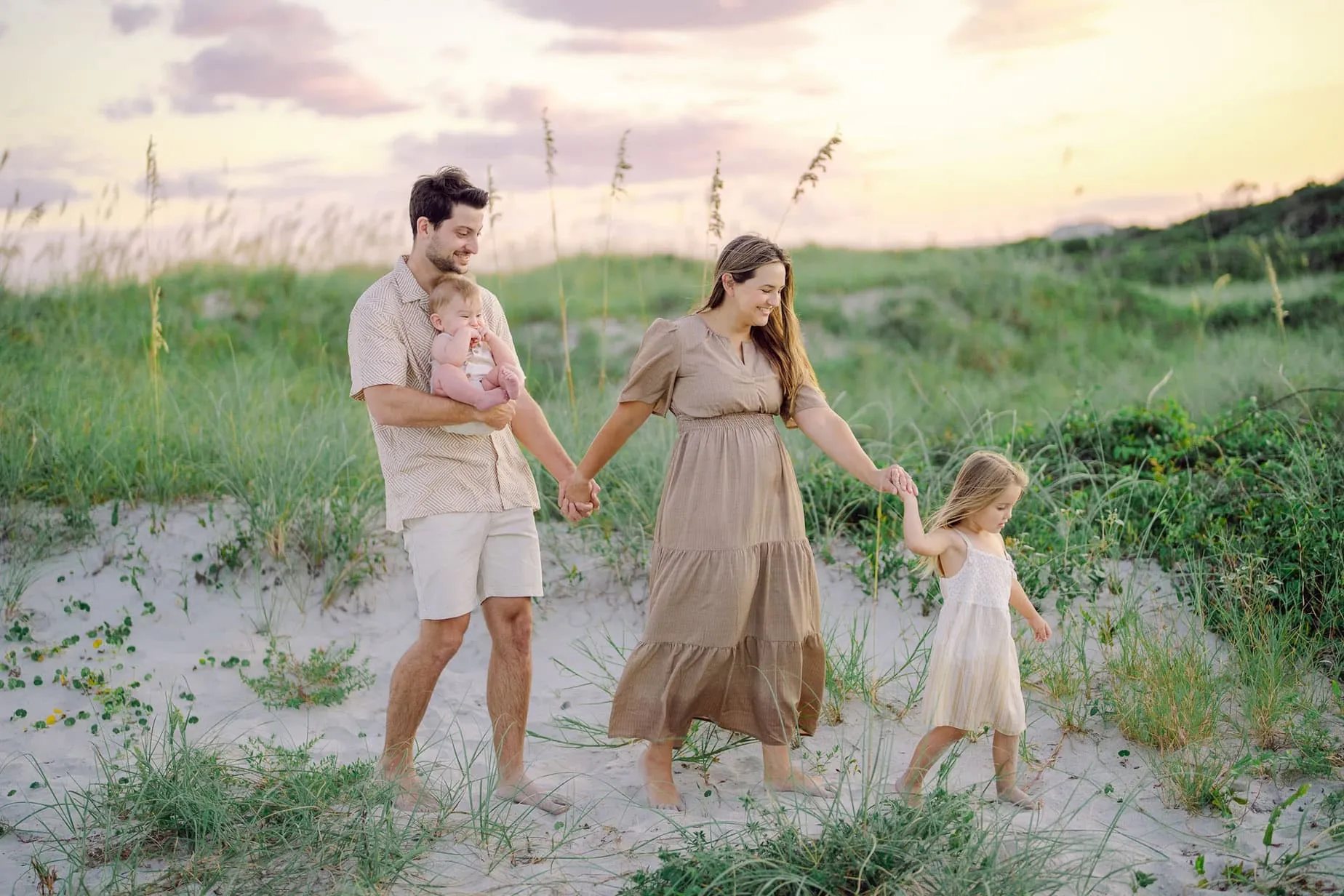 Parents holding toddler during Myrtle Beach family photography session