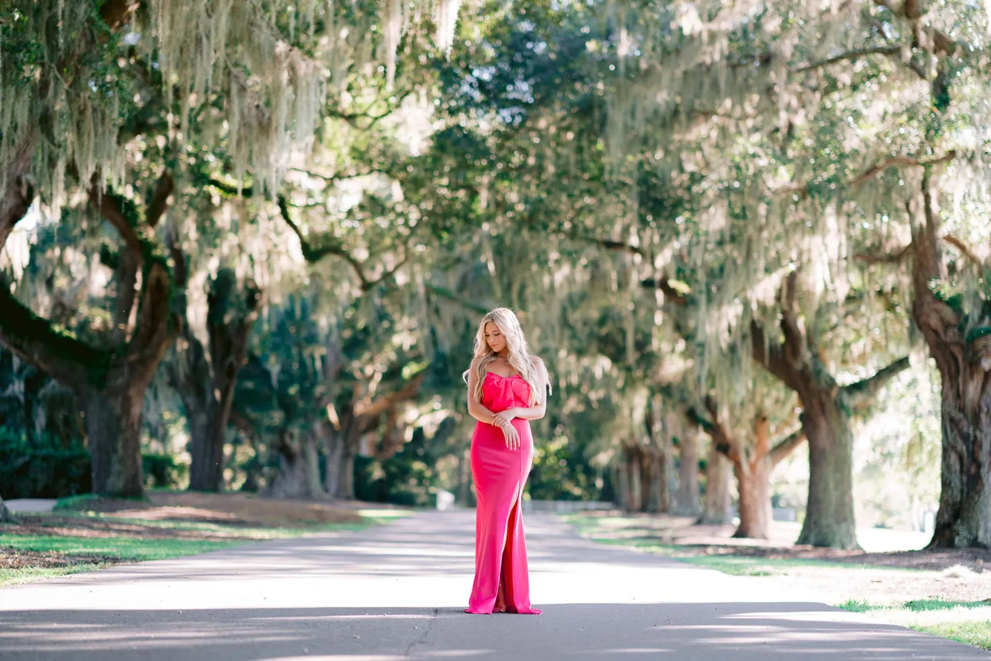 Senior portrait photographed in a South Carolina garden setting with soft light and natural posing by Pasha Belman Photography