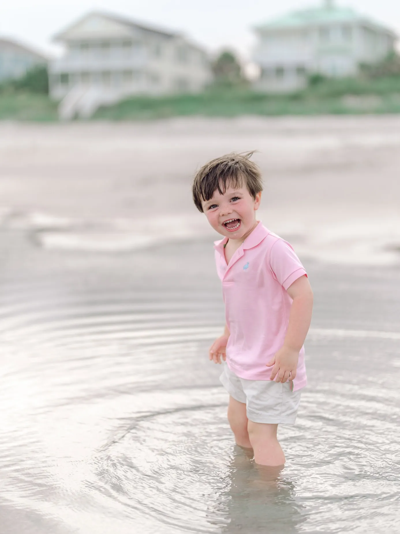 Young boy playing in the ocean during his family's Myrtle Beach beach session