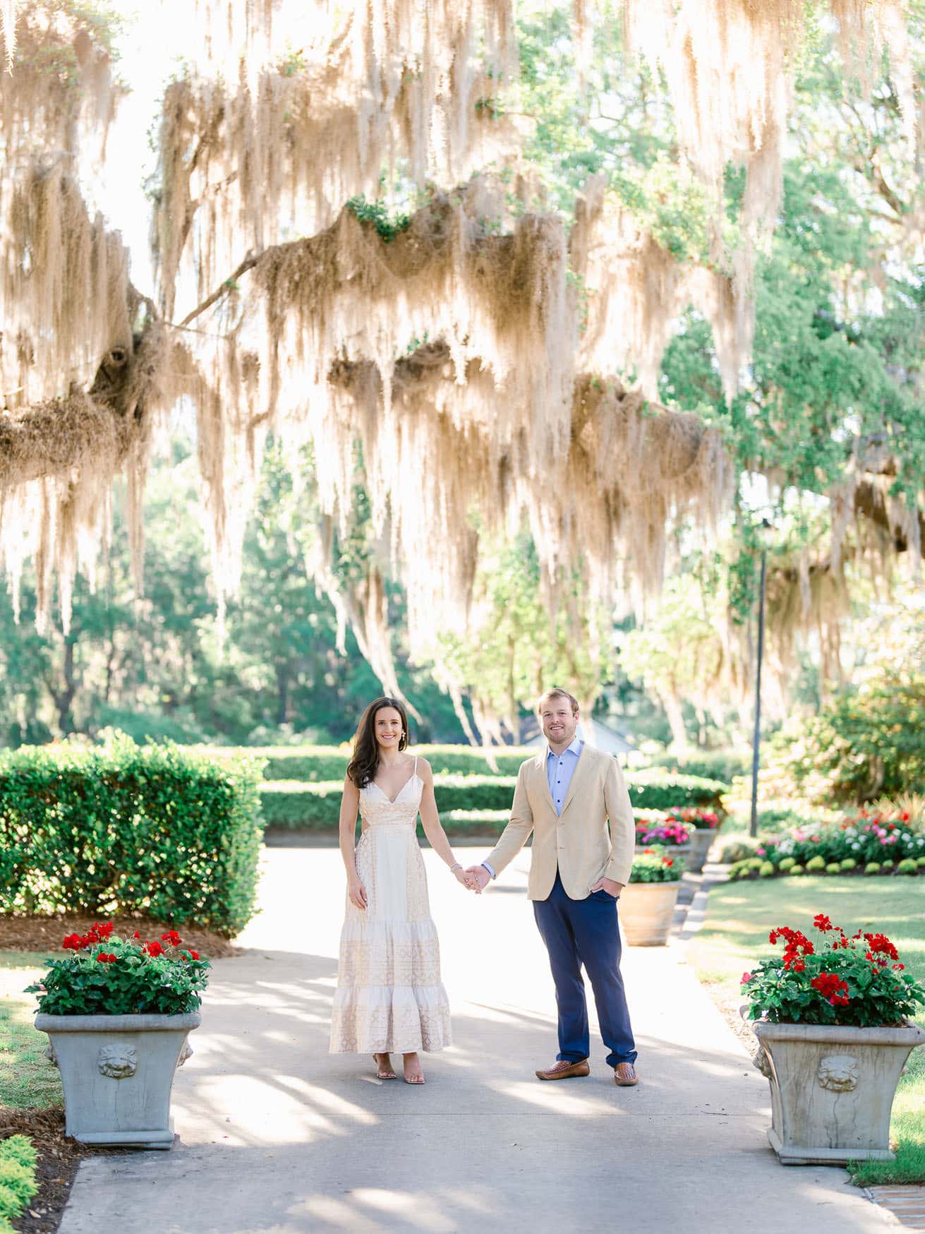 Engagement portraits at Caledonia Golf and Fish Club Pawleys Island featuring couple beneath Spanish moss and oak trees