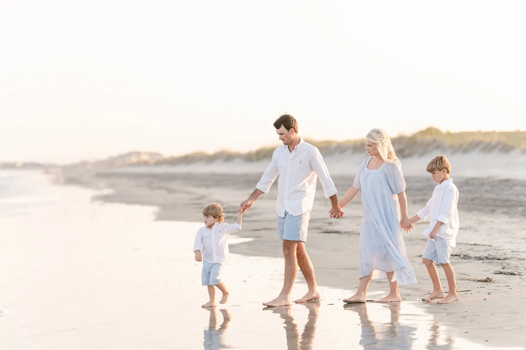 Candid family beach portraits at golden hour near Surfside Beach SC by Pasha Belman Photography