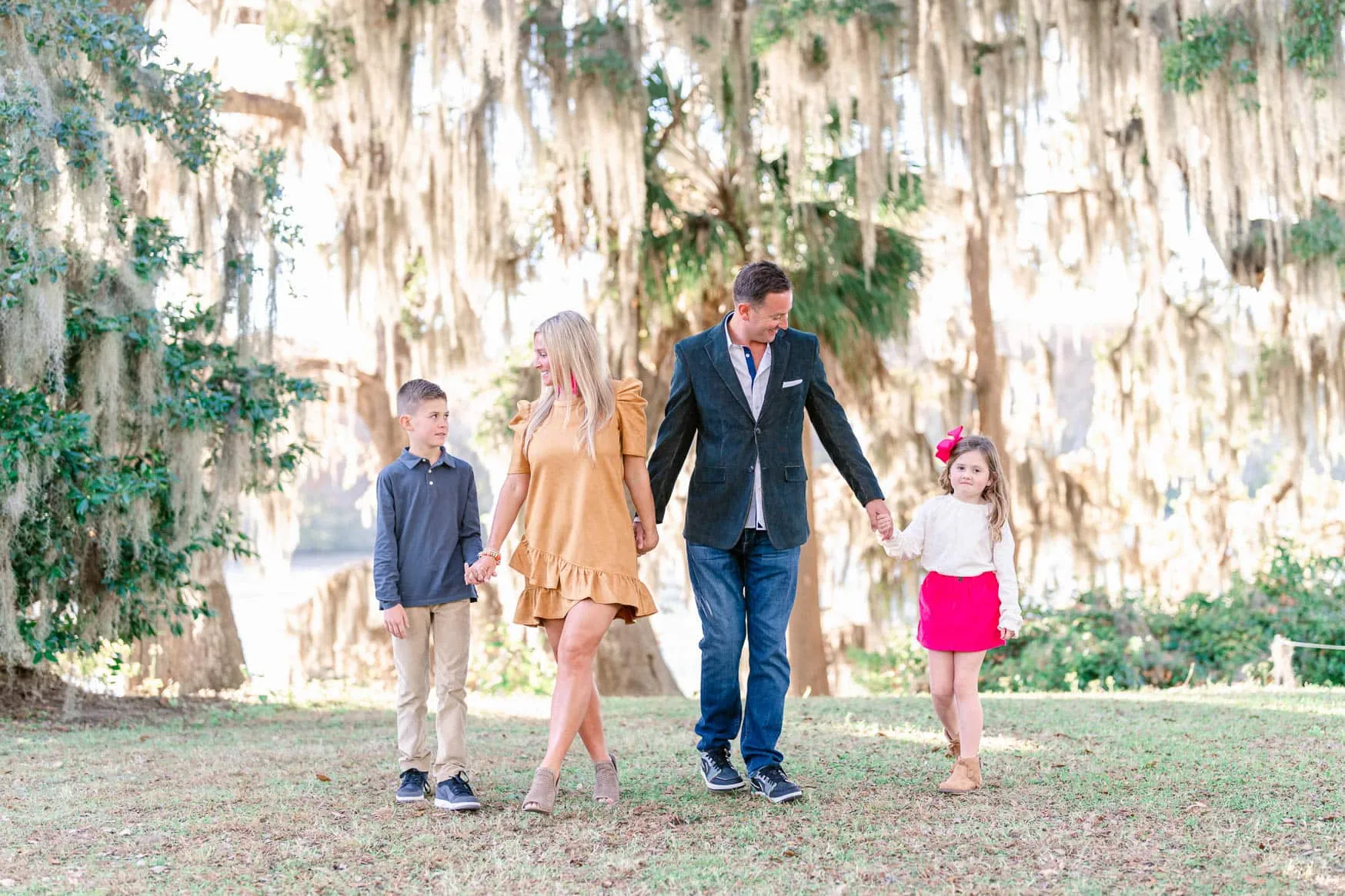 Family walking beneath Spanish moss during their Wachesaw portrait session