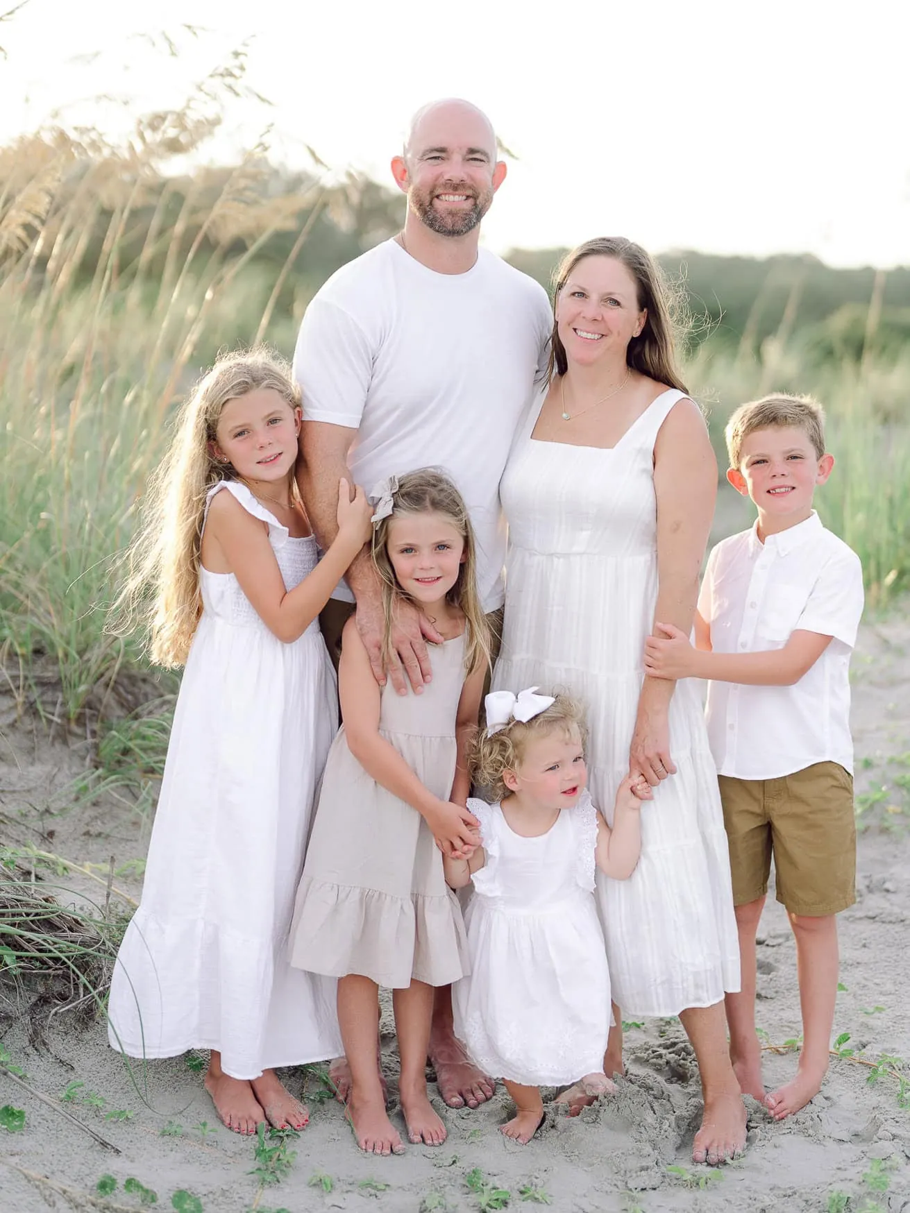 Family wearing cream and white clothing along the Murrells Inlet coast