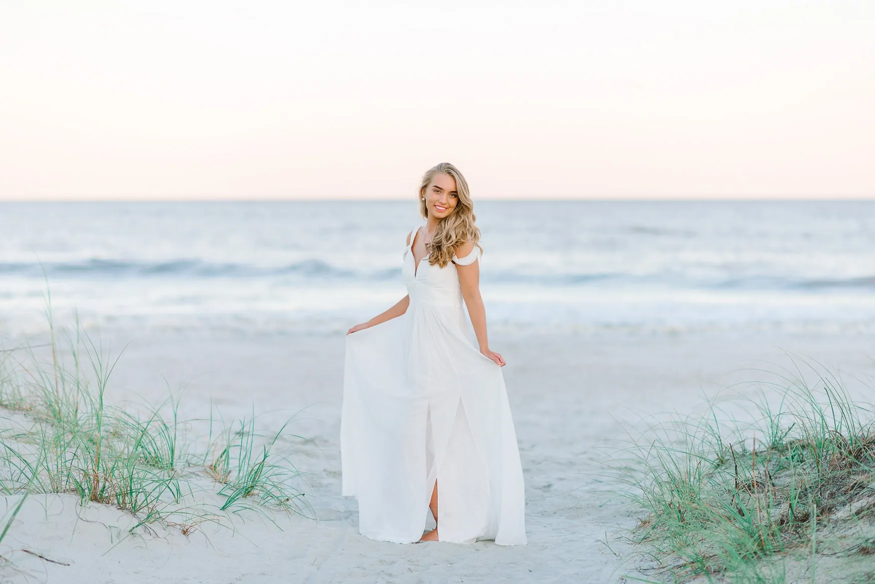 Natural senior portrait session on the beach during golden hour