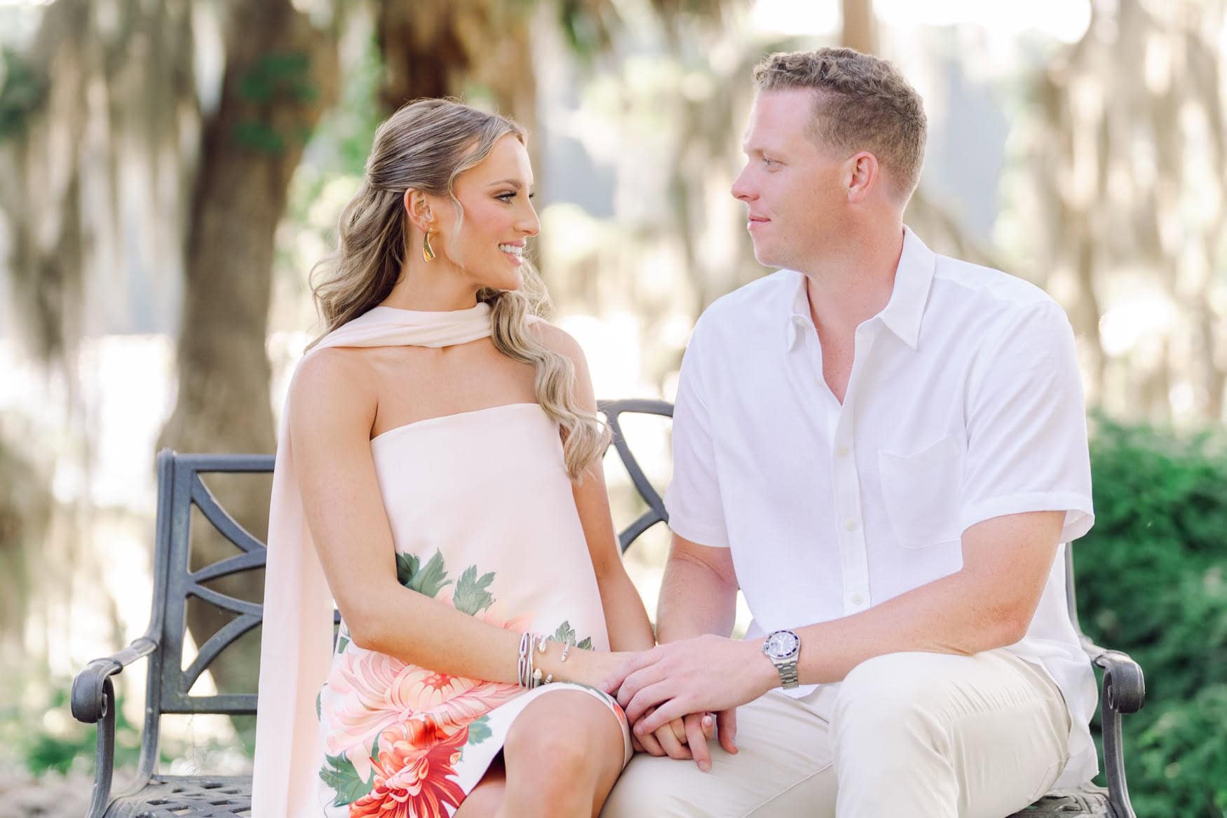Engaged couple laughing together under the live oak canopy in Pawleys Island South Carolina