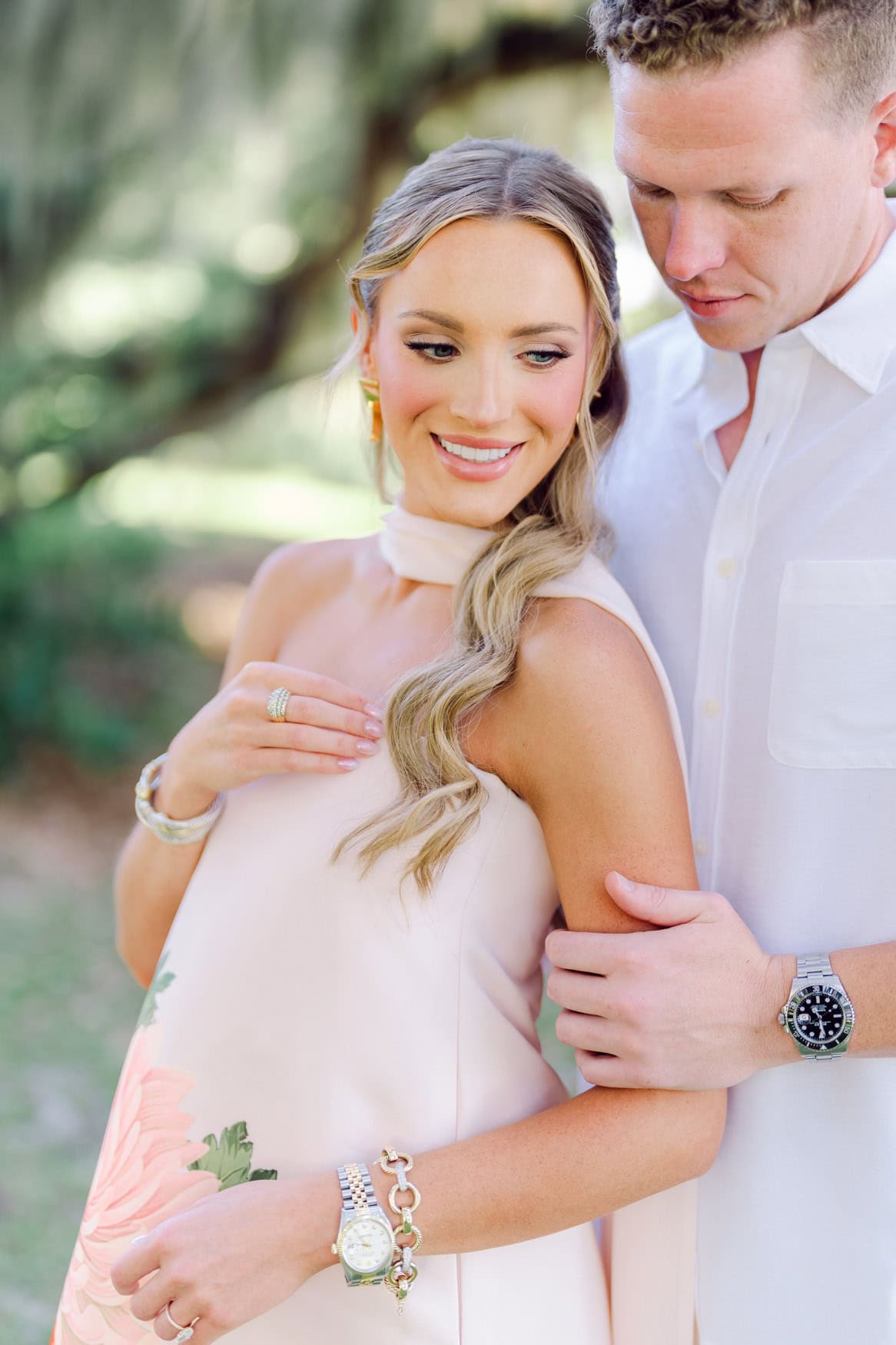 Couple laughing and relaxed during their engagement session under the Spanish moss in Pawleys Island South Carolina