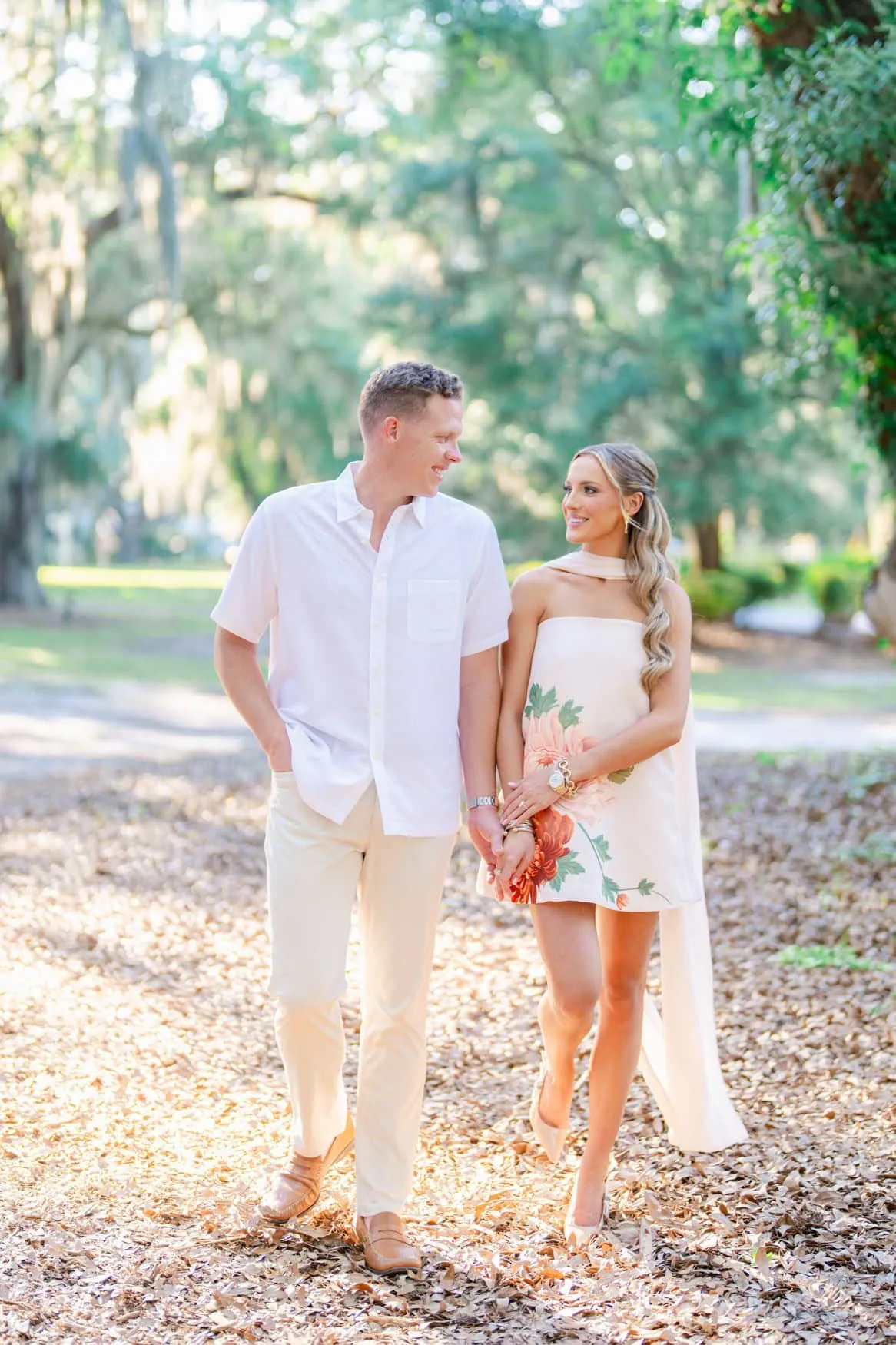 Couple in coordinated blush and white outfits during their Pawleys Island SC engagement photos