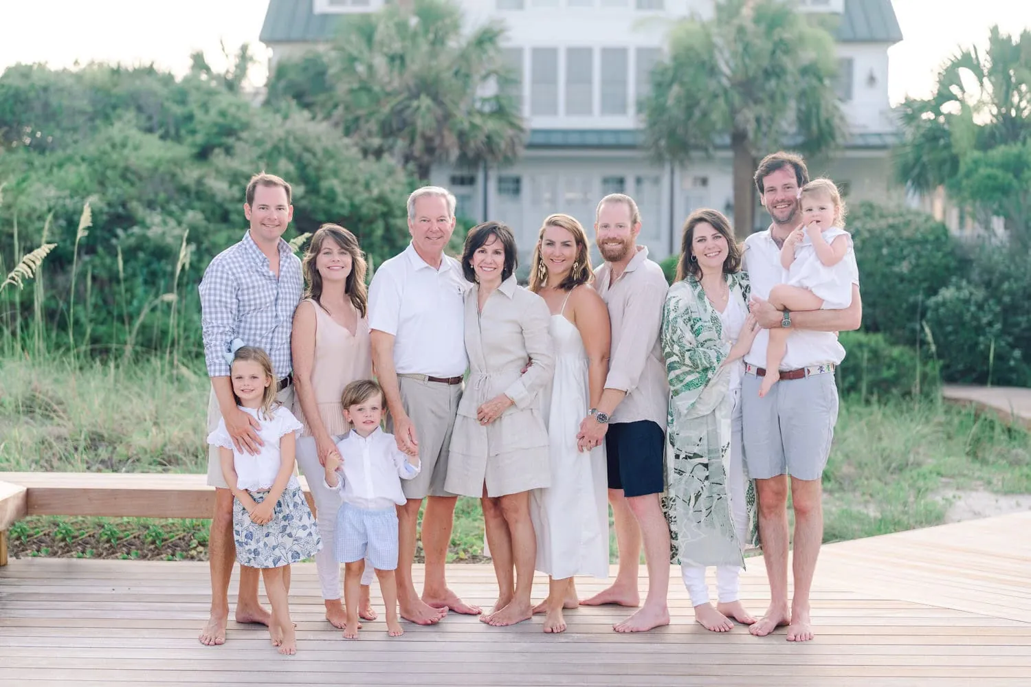 Family wearing coordinated blue, white, and neutral outfits for family beach photos in Myrtle Beach, South Carolina.