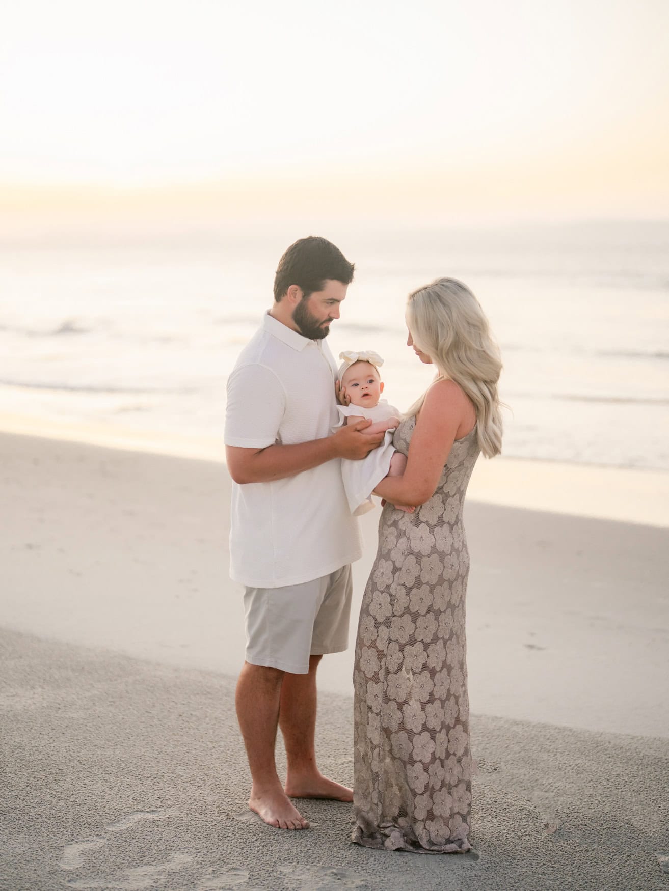 Family walking together on the beach at sunrise in Pawleys Island