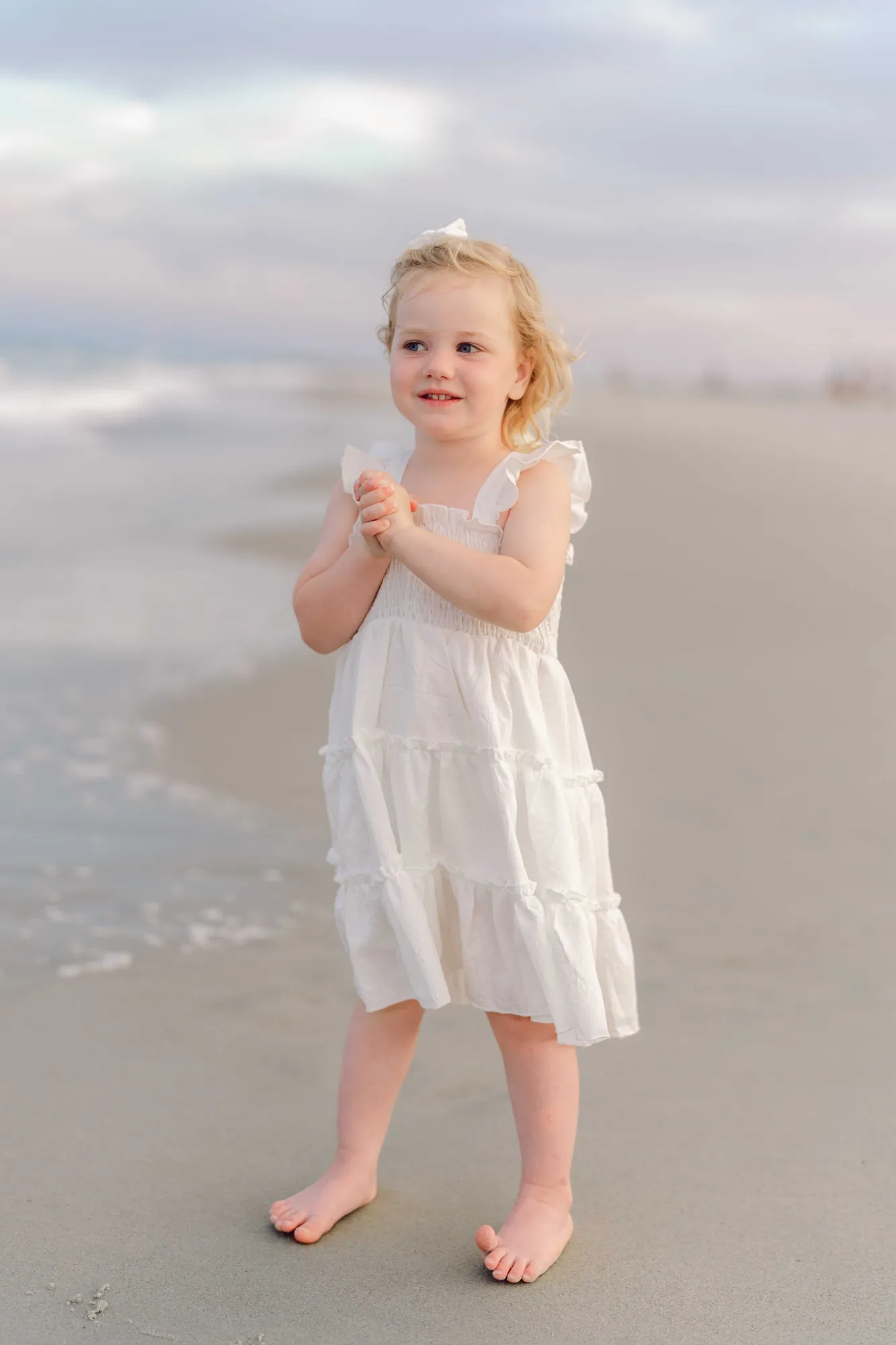 Children running while their parents walk together on Pawleys Island beach.