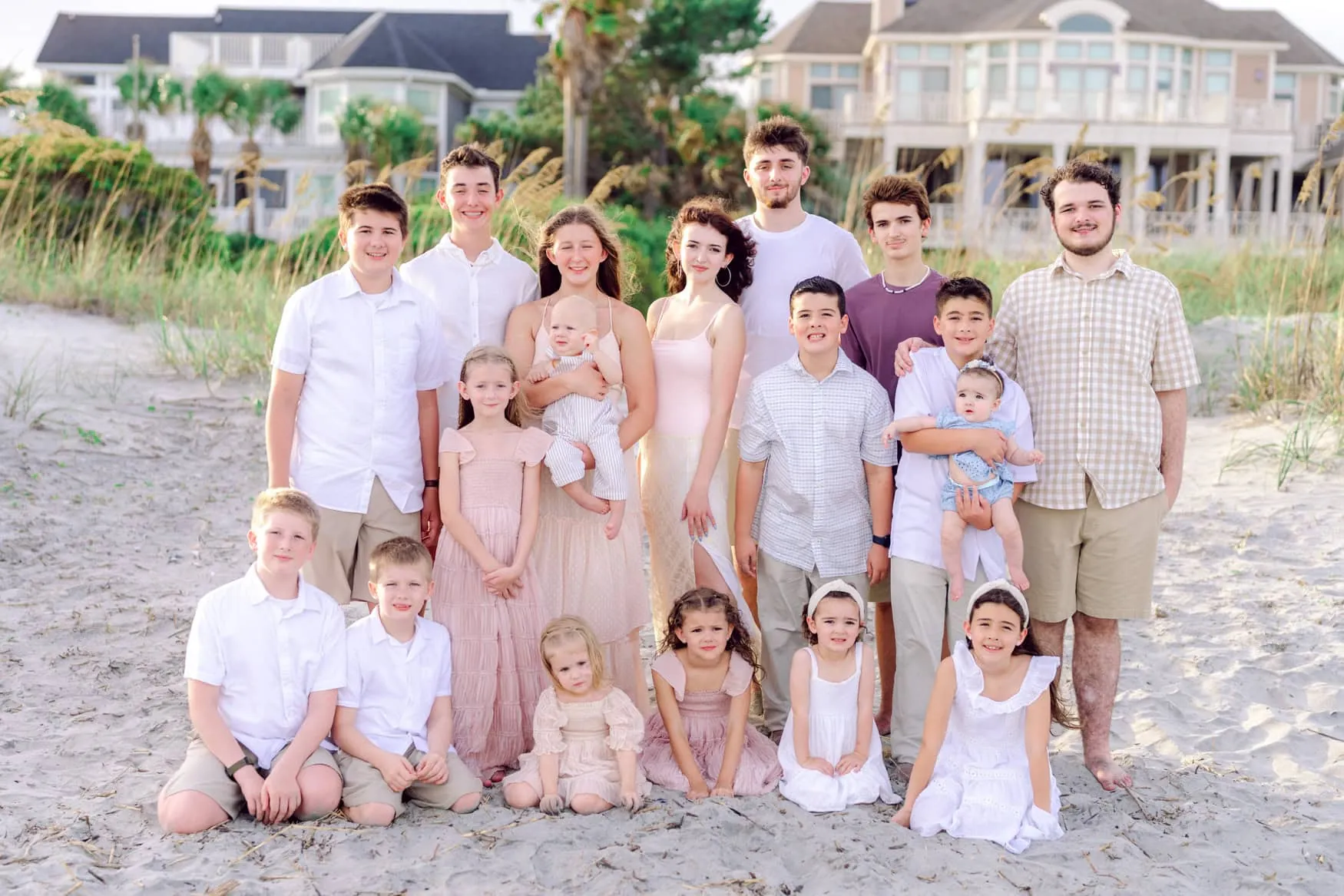 Cousins and siblings gathered for a children's beach portrait at Isle of Palms near Wild Dunes Resort in Charleston, South Carolina, during a golden hour extended family photography session.