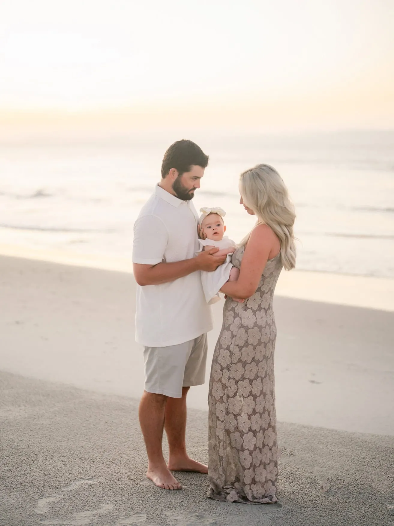 Family walking together on the beach at sunrise in Pawleys Island