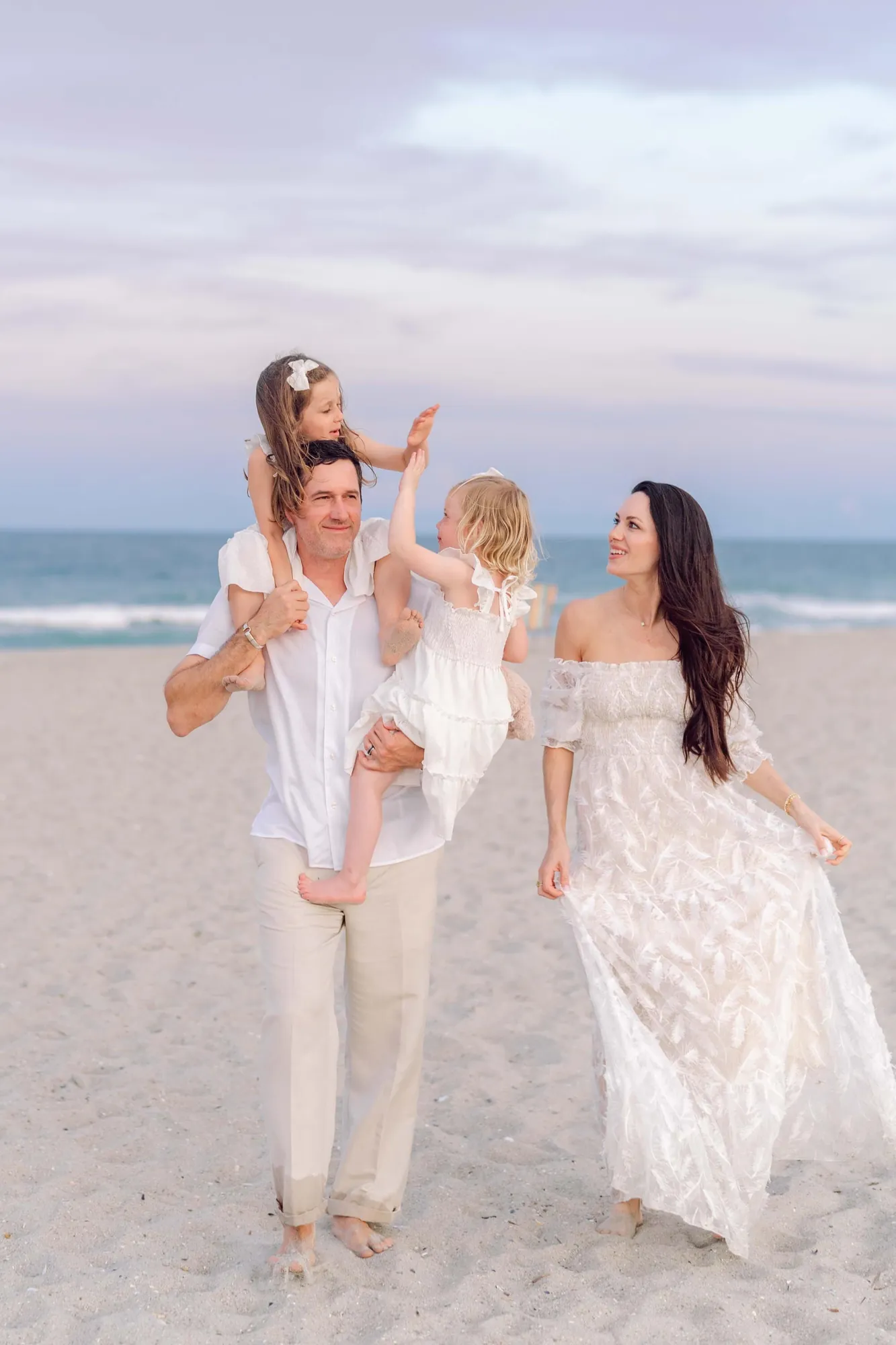Father carrying both daughters during a relaxed Pawleys Island beach family photography session.