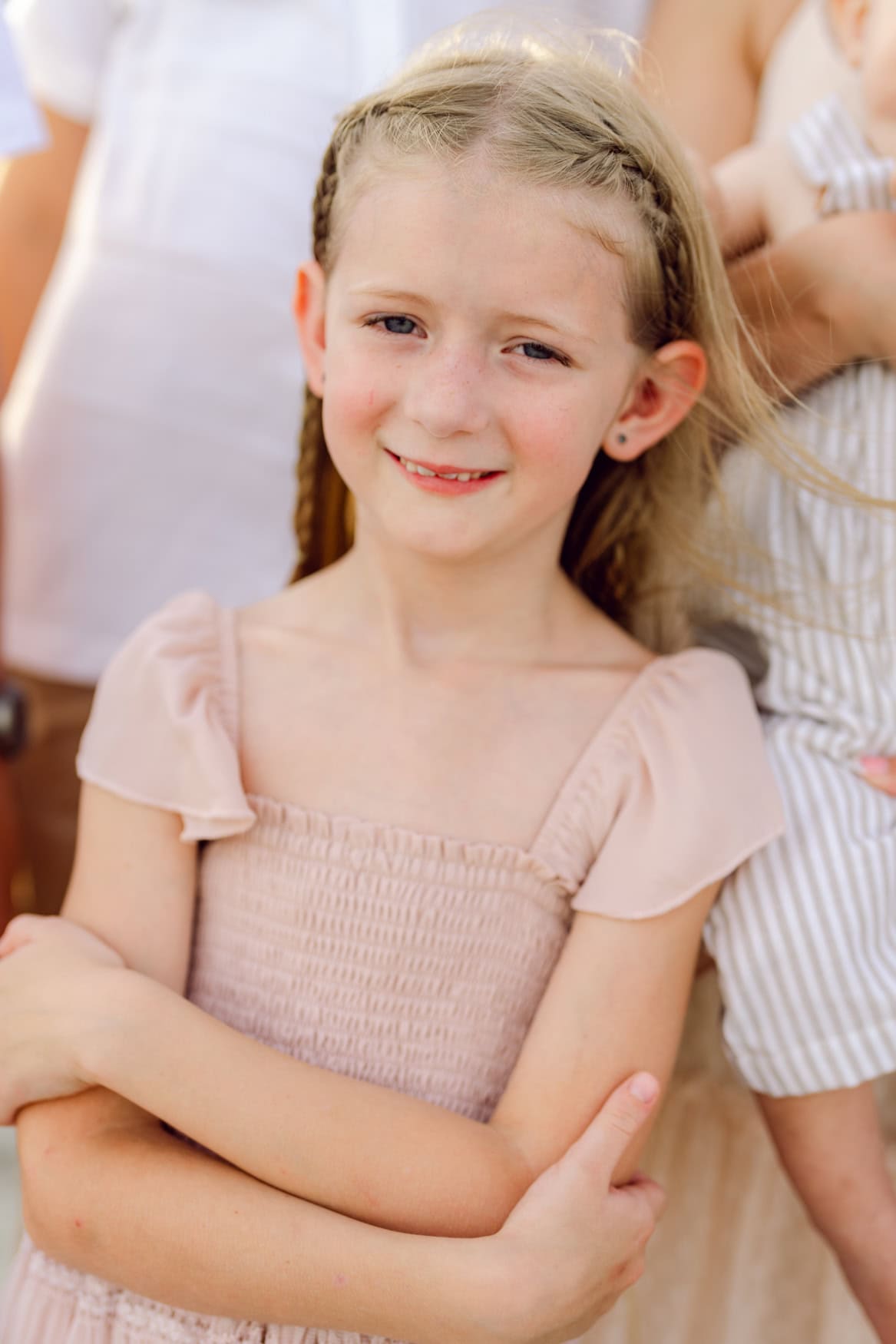 Young girl smiling during a family beach photography session at Wild Dunes Resort in Isle of Palms near Charleston, South Carolina. Natural child portrait captured on the beach during a family vacation.