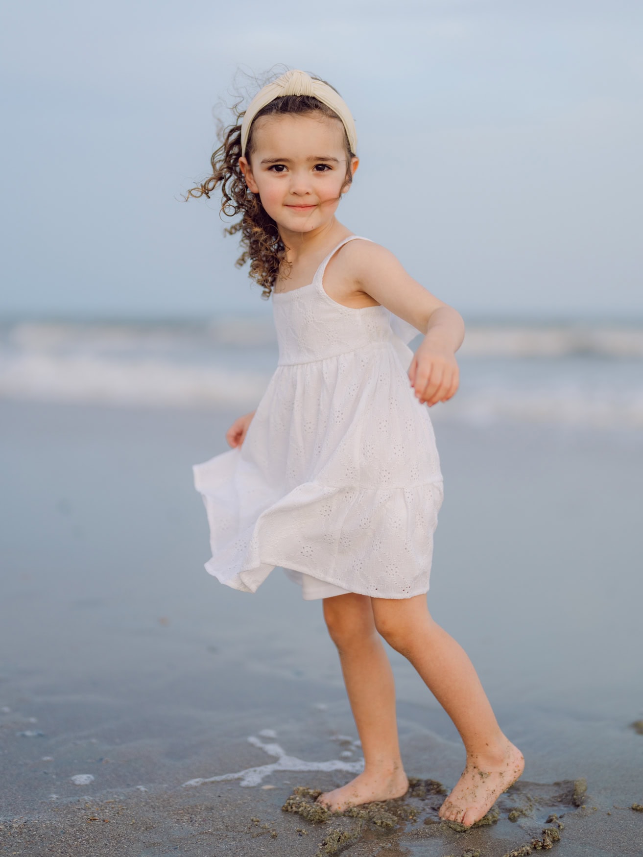 Natural beach family portrait with ocean backdrop