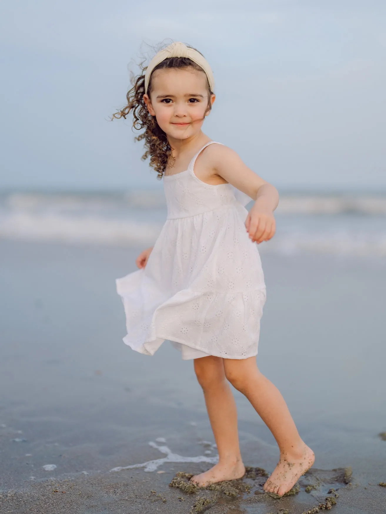 Natural beach family portrait with ocean backdrop