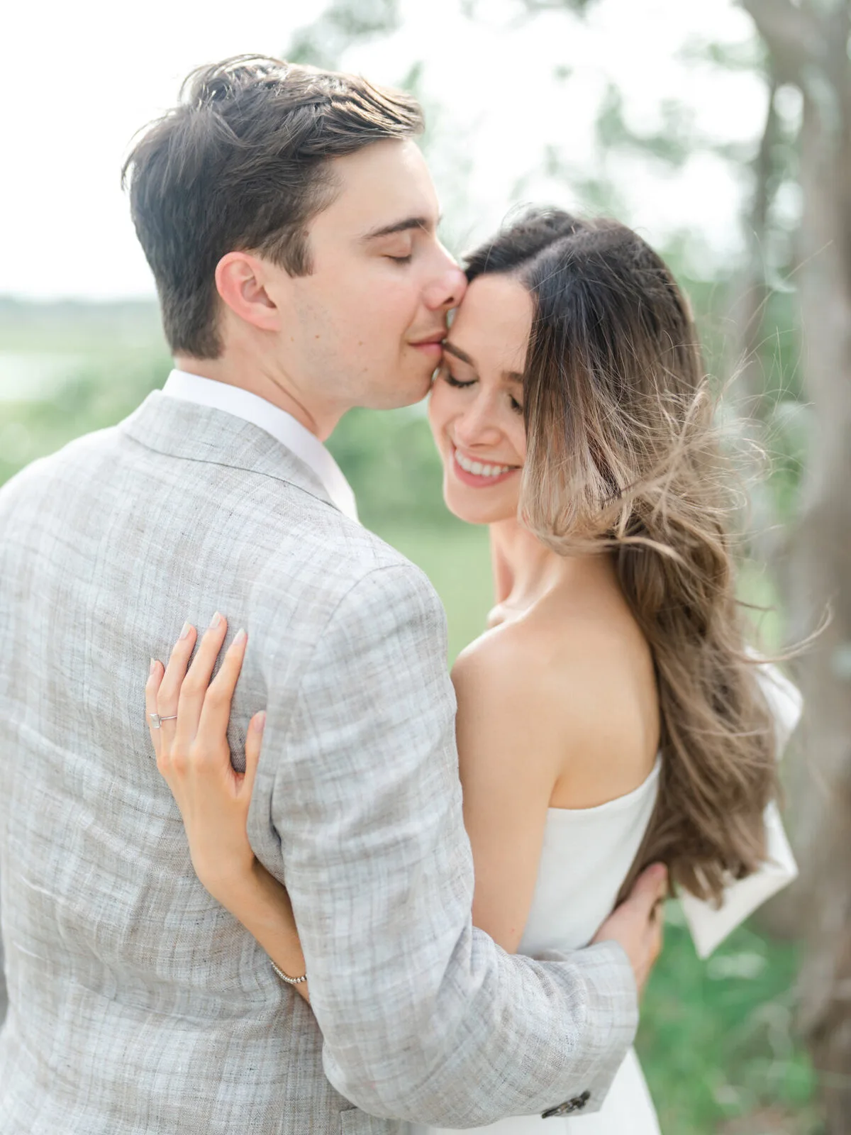 Close-up of an engaged couple embracing outdoors in Charleston SC