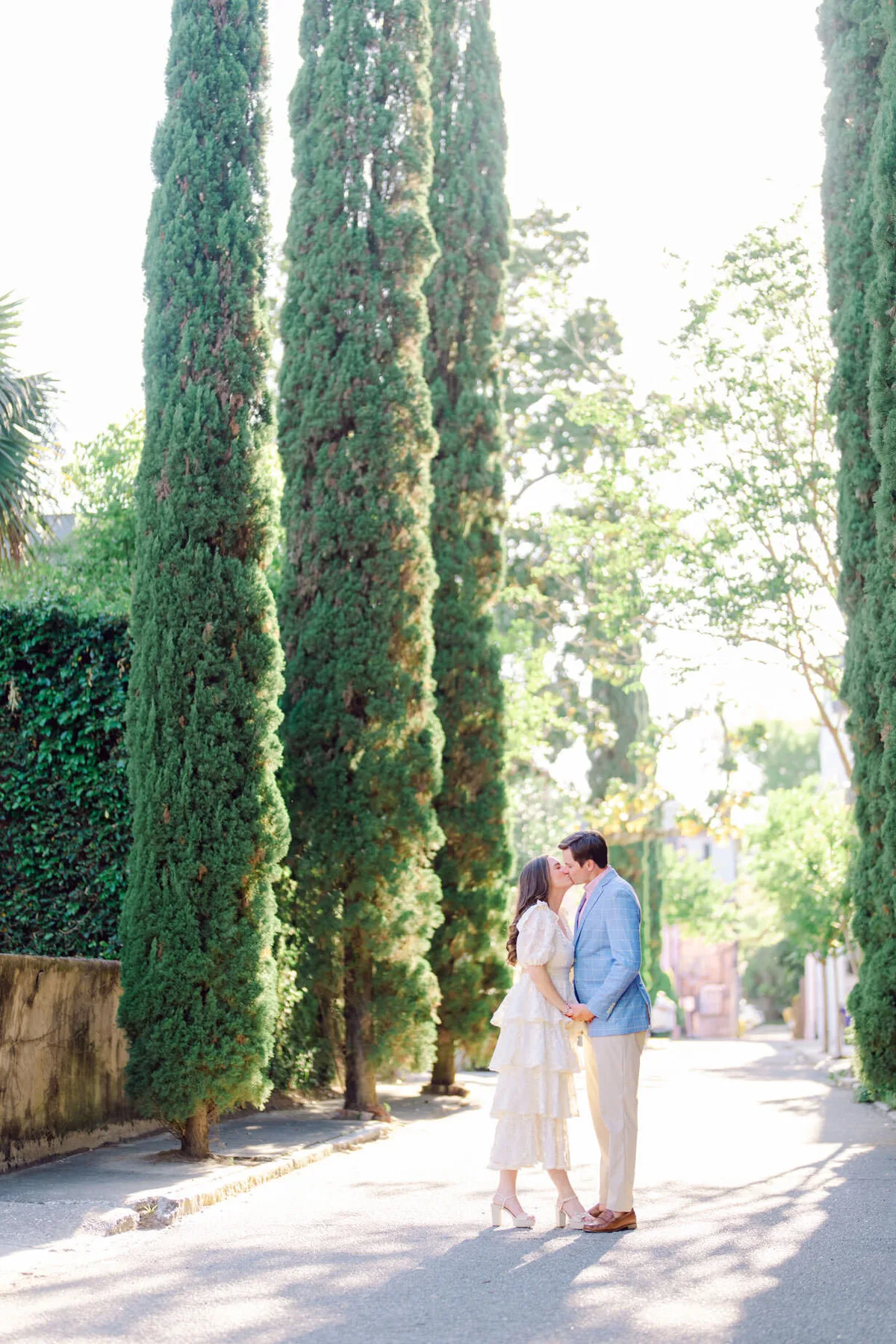 Engaged couple kissing beneath cypress trees in Charleston SC