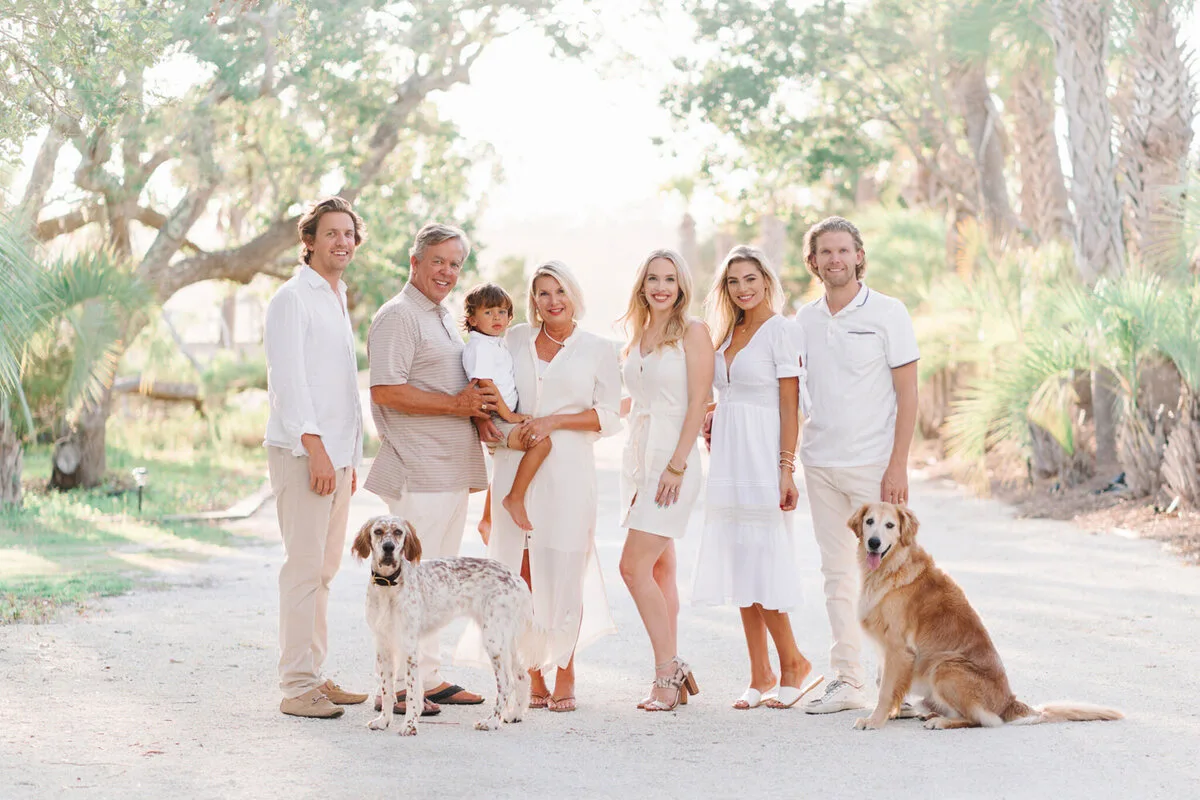 Family with two dogs under the live oaks near Charleston SC