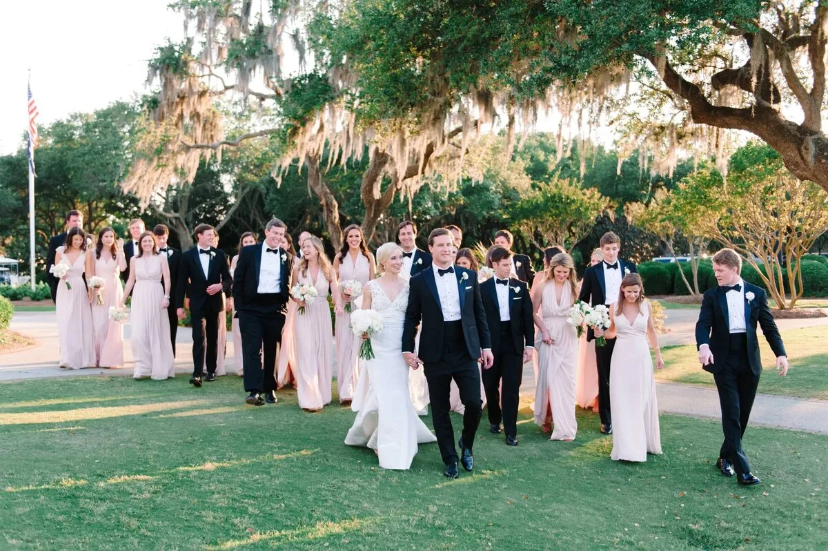 Wedding party walking under live oaks at a Charleston SC live oak wedding