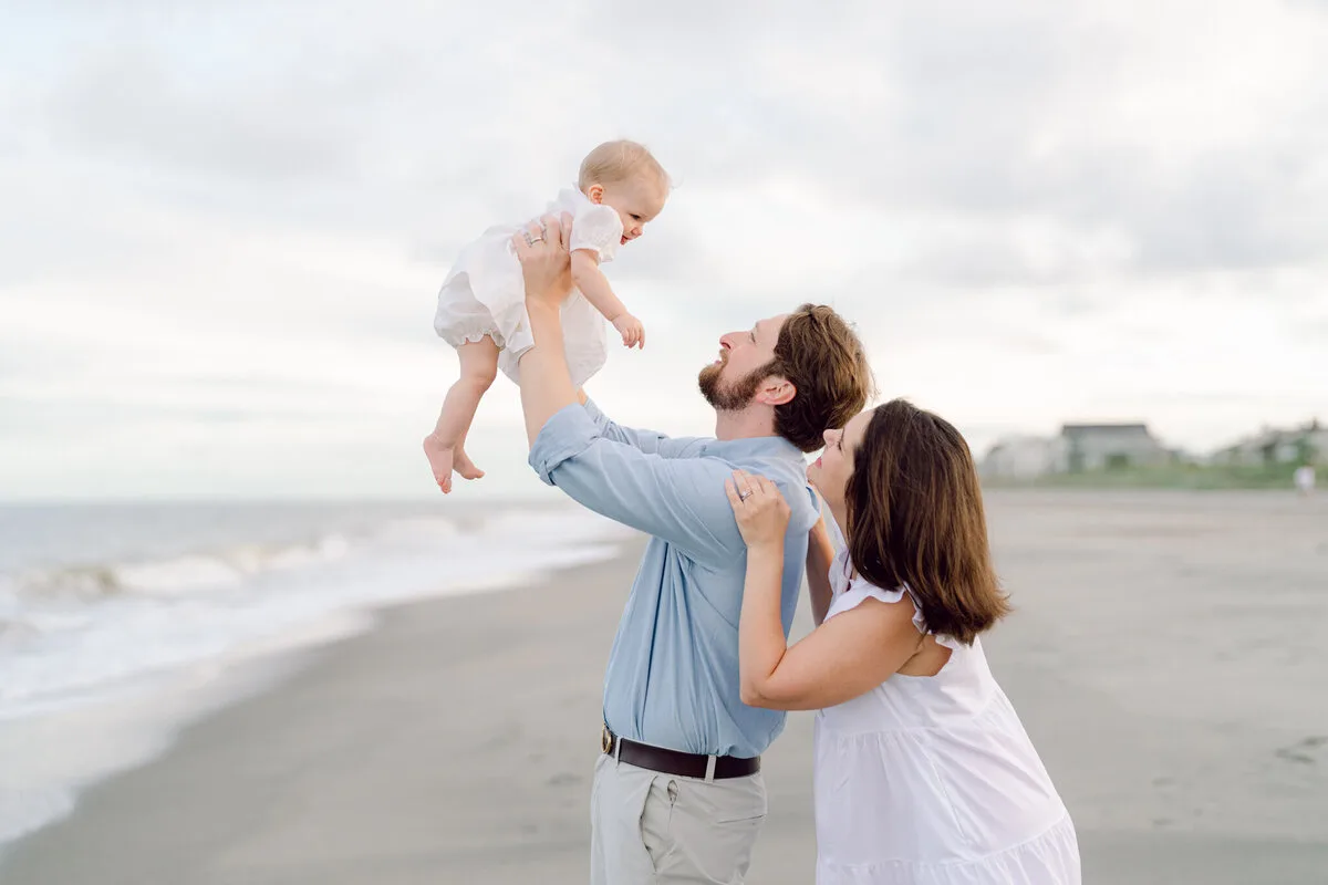Dad lifting his baby on DeBordieu Beach in Georgetown SC