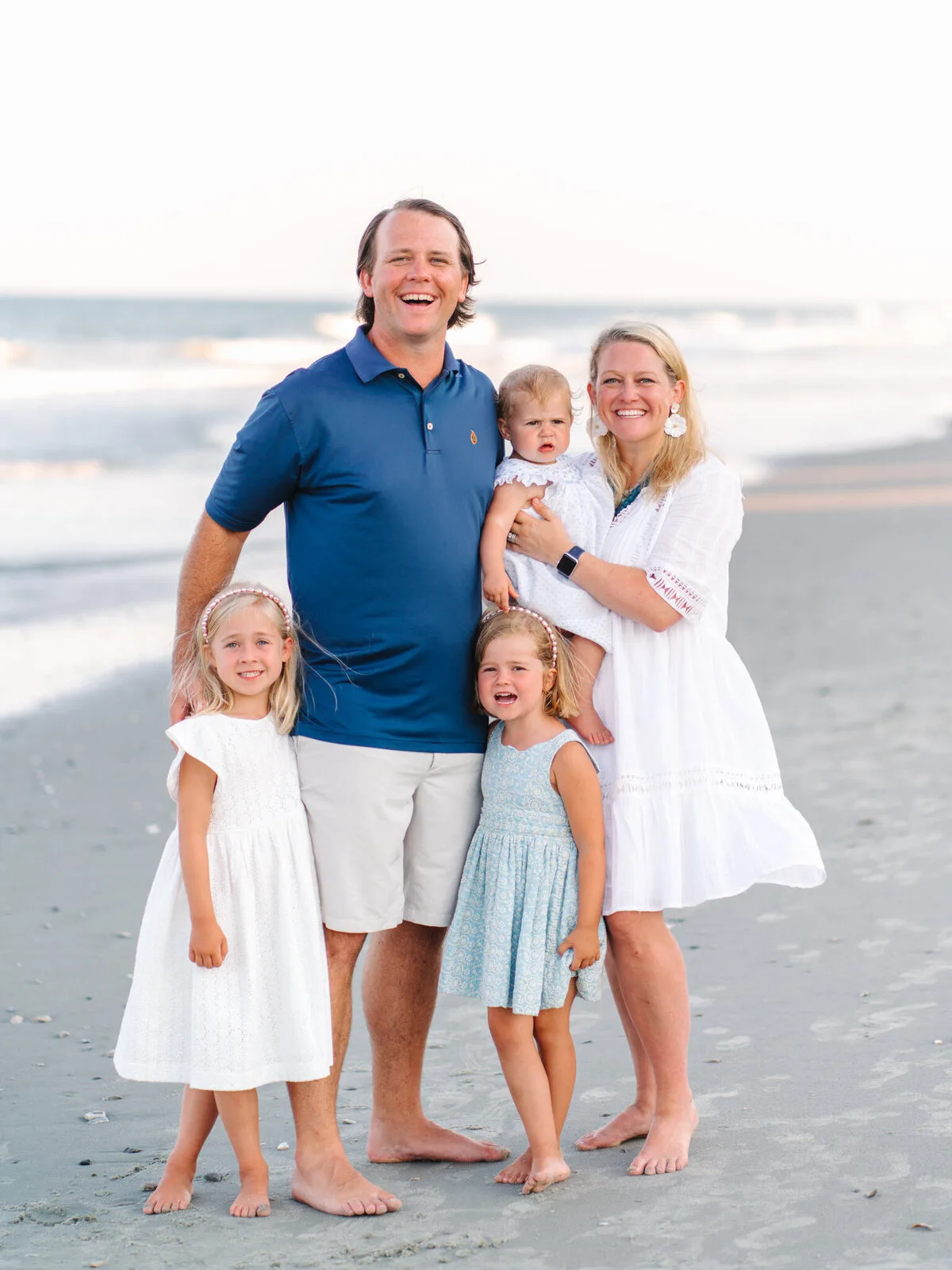Family of five at the shoreline on DeBordieu Beach in Georgetown SC